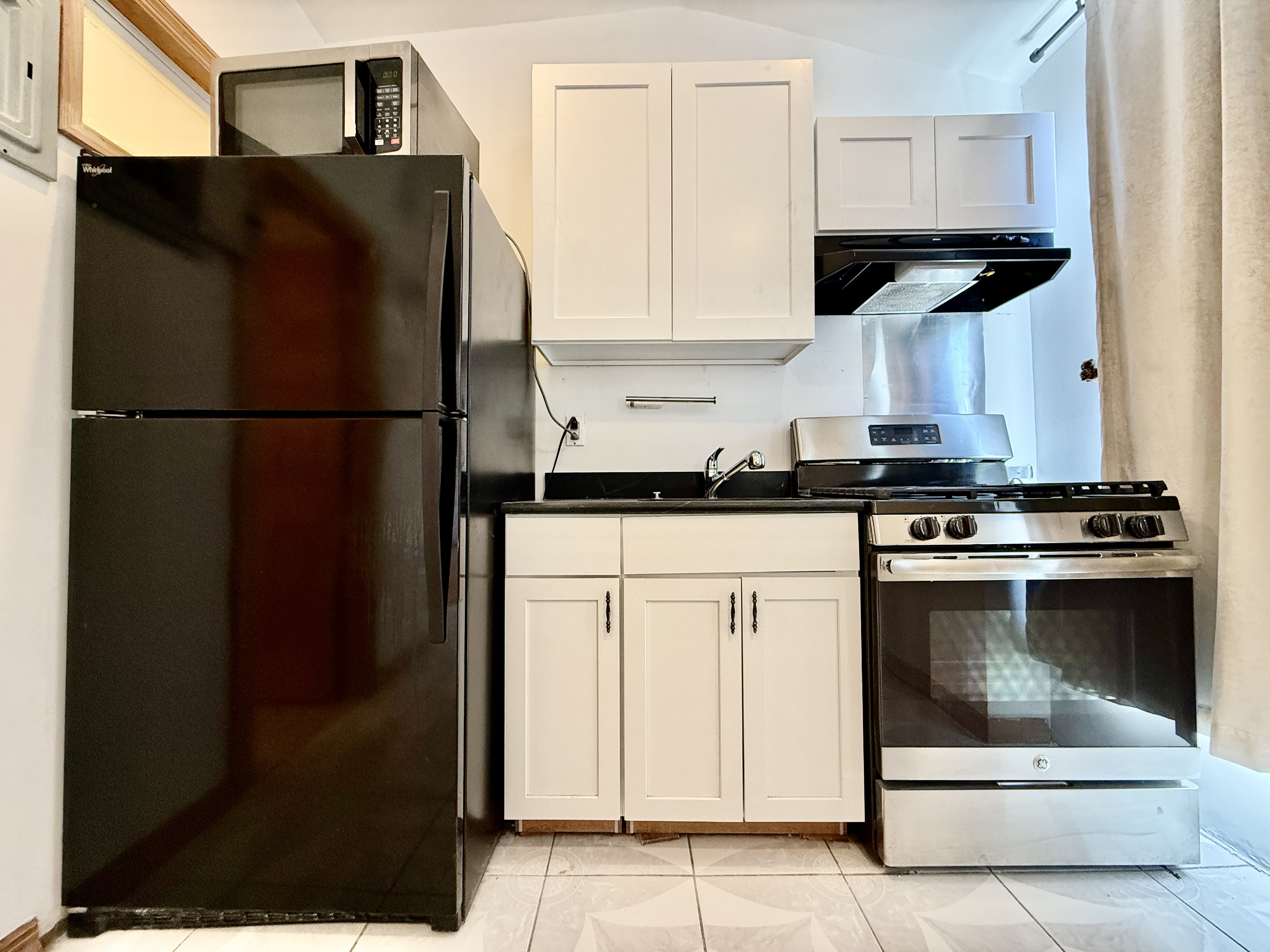 295 Greene Avenue, Unit 2 Brooklyn, NY 11238 - Photo 4 of 6 a kitchen with a refrigerator and a stove