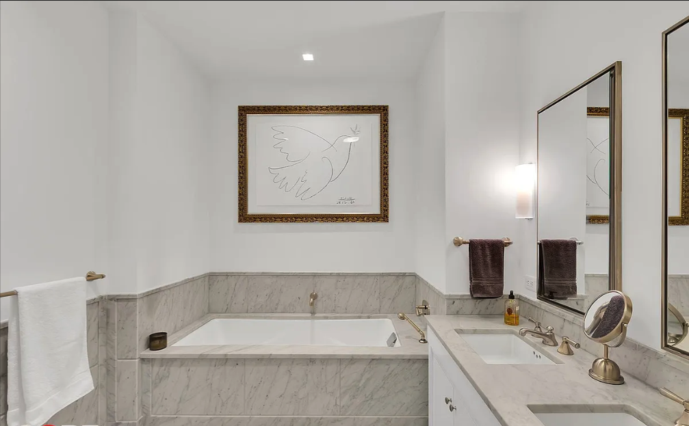 10 Madison Square West, Unit 9G Manhattan, NY 10010 - Photo 6 of 13 a bathroom with a tub sink and mirror