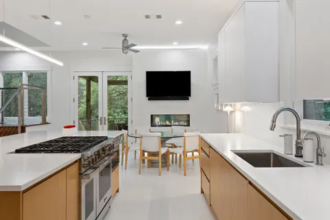 a kitchen with stainless steel appliances a stove a sink a microwave and a refrigerator