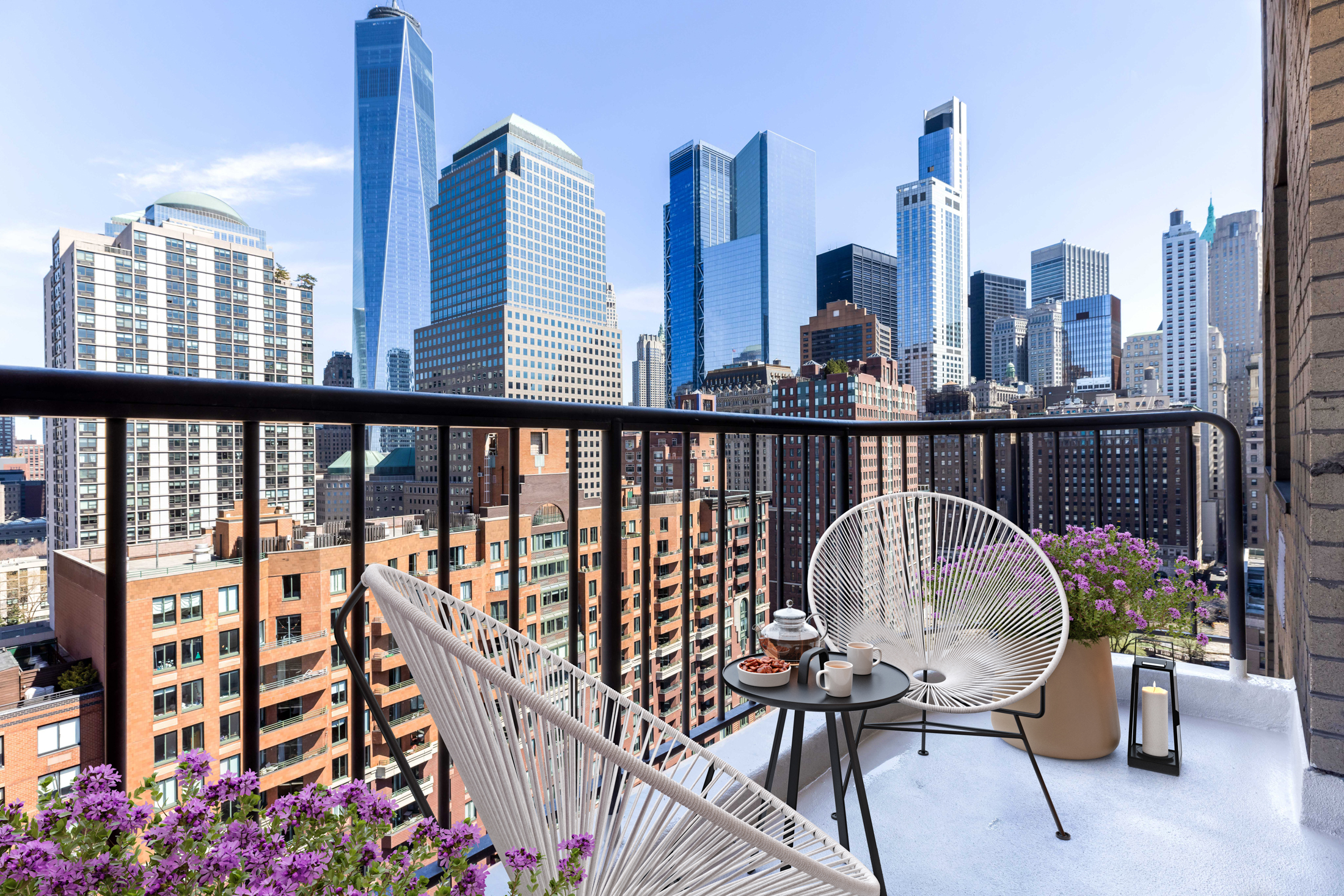 380 Rector Place, Unit 18C Manhattan, NY 10280 - Photo 1 of 14 a view of a balcony with chairs and wooden fence