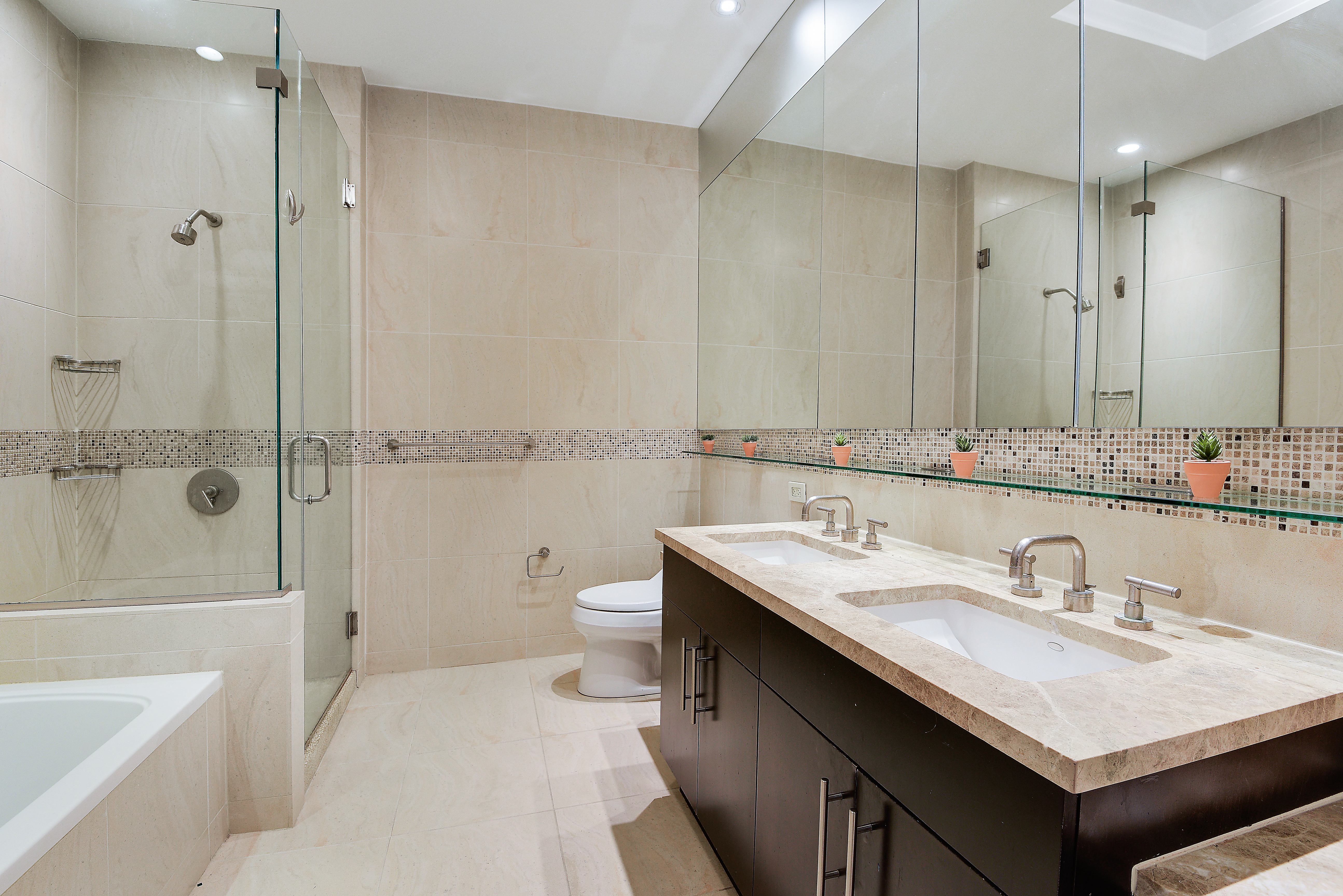 325 5th Avenue, Unit 16C Manhattan, NY 10016 - Photo 8 of 25 a bathroom with a sink toilet double vanity and tub