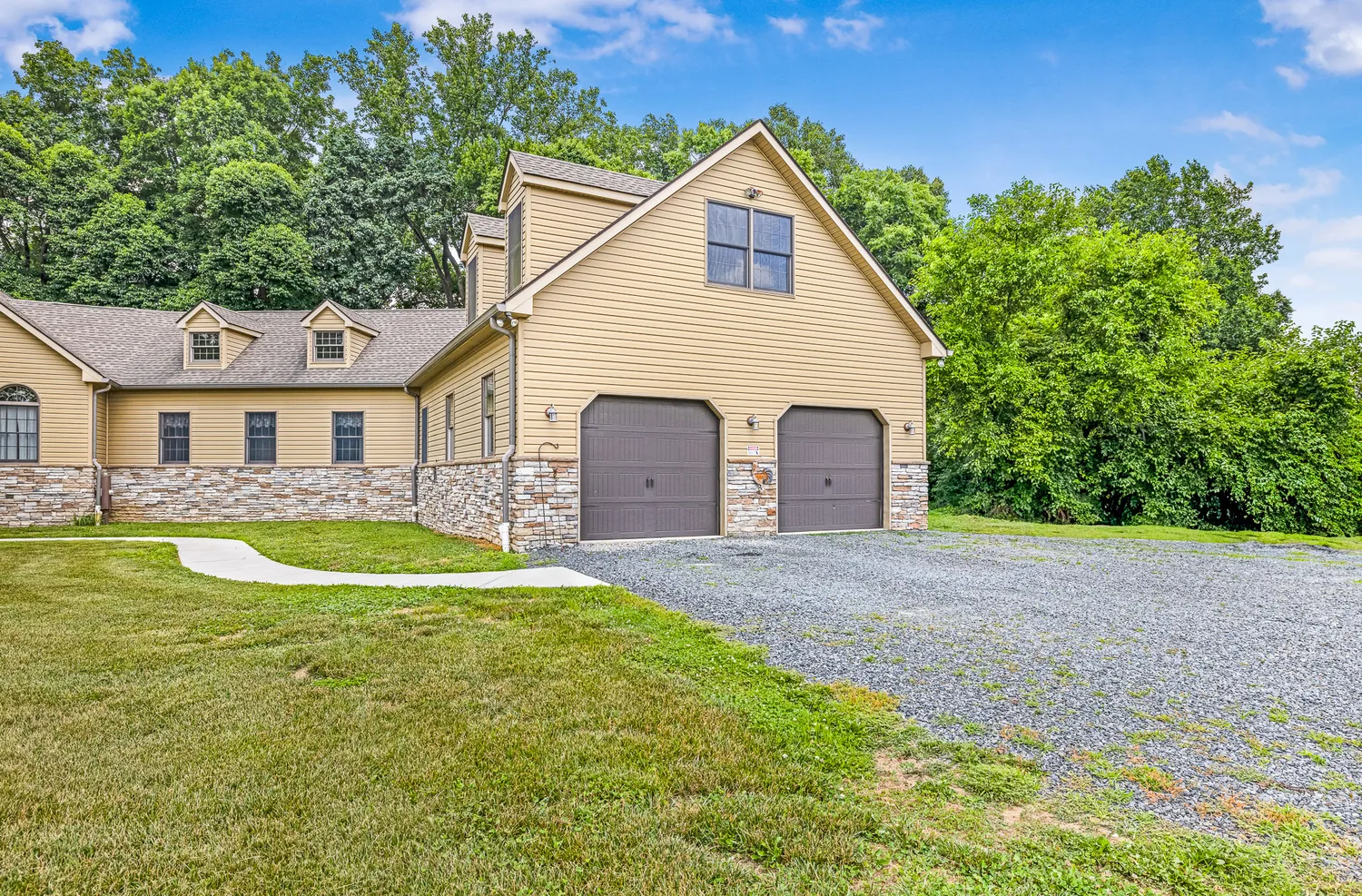 a view of a white house with a swimming pool and a yard