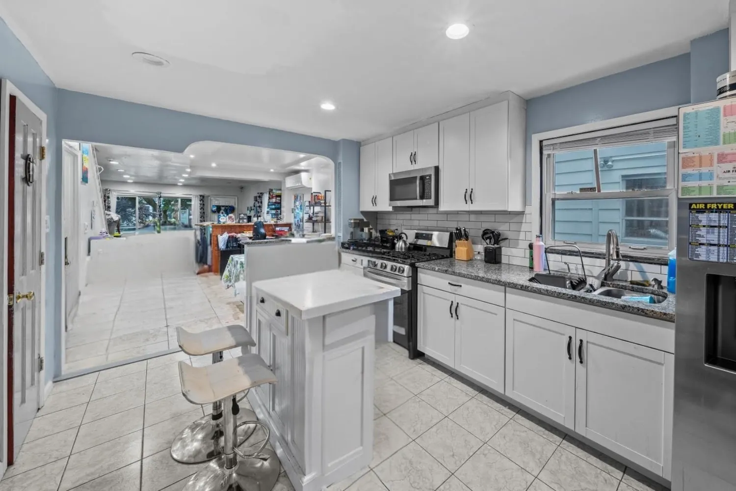 a kitchen with stainless steel appliances granite countertop a sink and cabinets