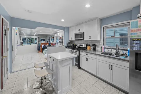 a kitchen with stainless steel appliances granite countertop a sink and cabinets