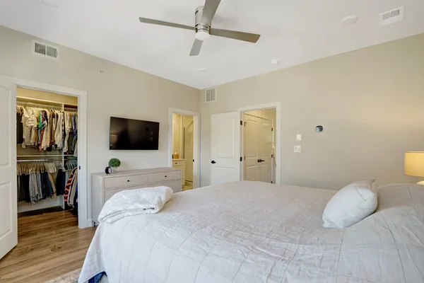 a bedroom with a bed and a flat screen tv