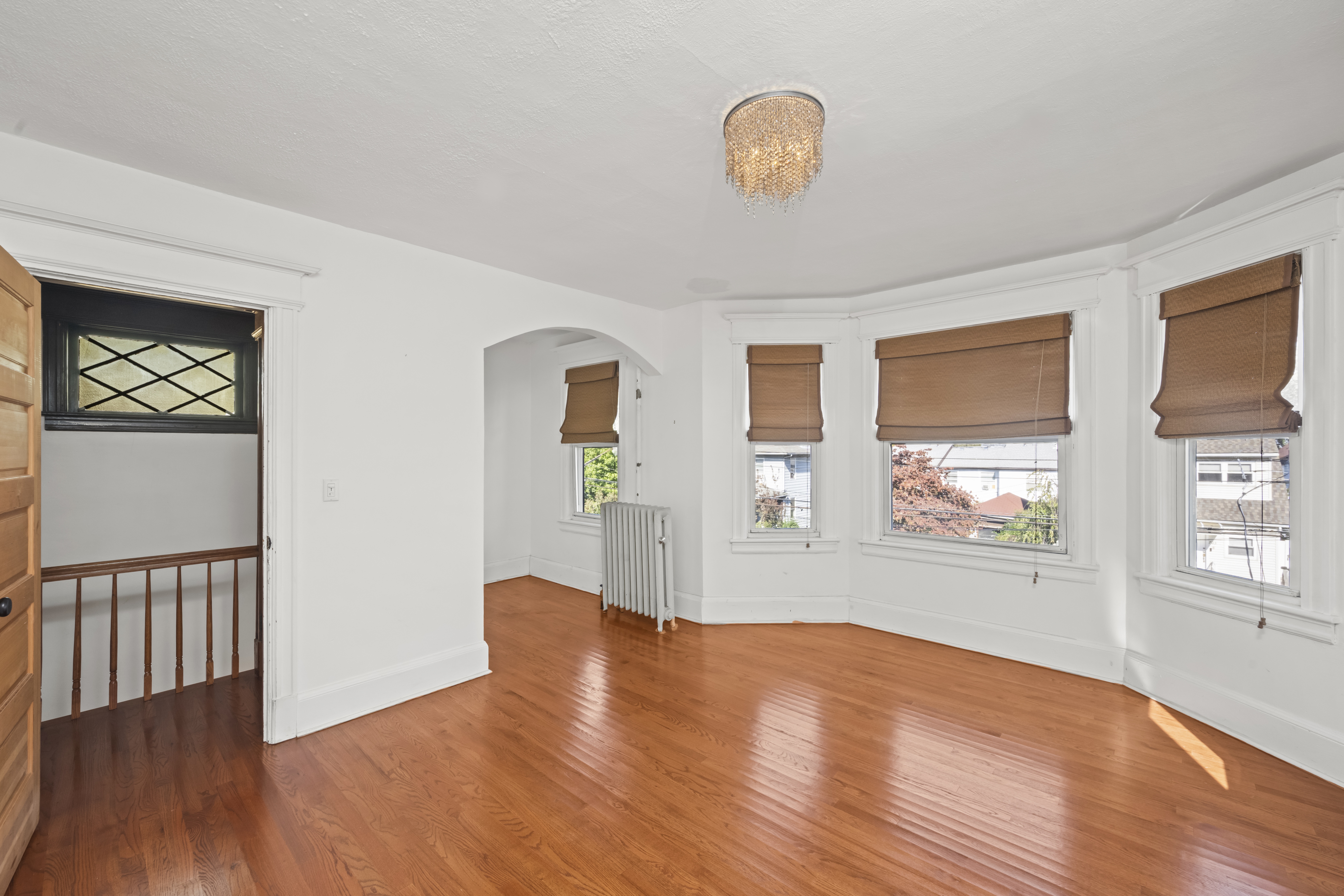704 Delafield Avenue Staten Island, NY 10310 - Photo 15 of 35 a view of empty room with wooden floor and fan