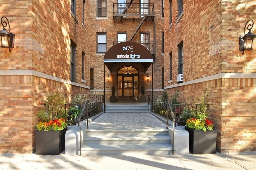 a front view of a building with potted plants