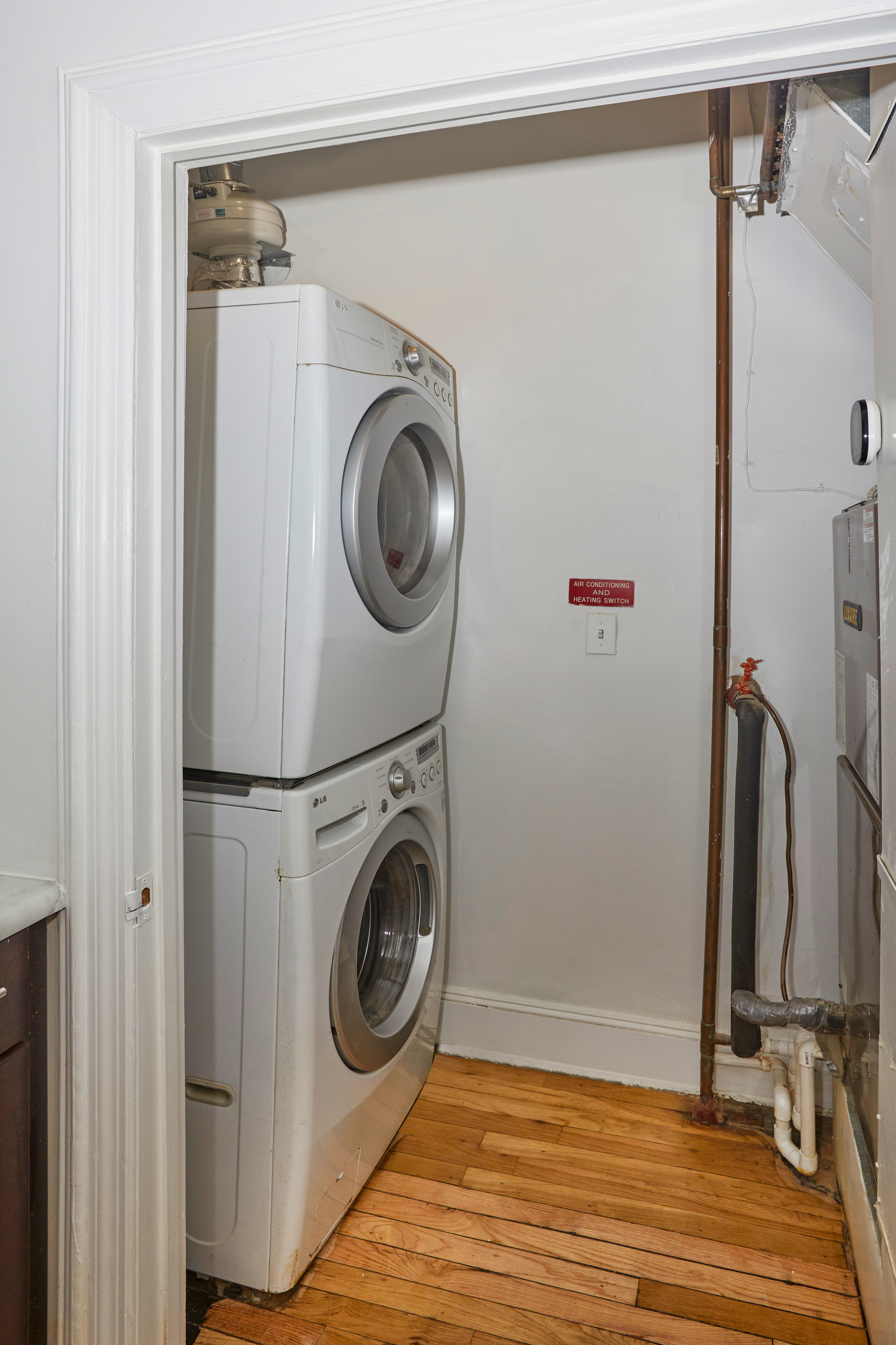 80 Leonard Street, Unit 3G Manhattan, NY 10013 - Photo 27 of 30 a utility room with dryer and washer