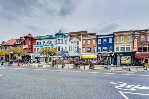 a group of people sitting in front of building