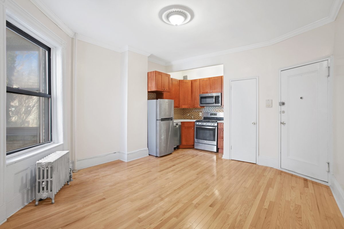 155 Garfield Place, Unit 3B Brooklyn, NY 11215 - Photo 1 of 6 a kitchen with stainless steel appliances a refrigerator and a wooden floor