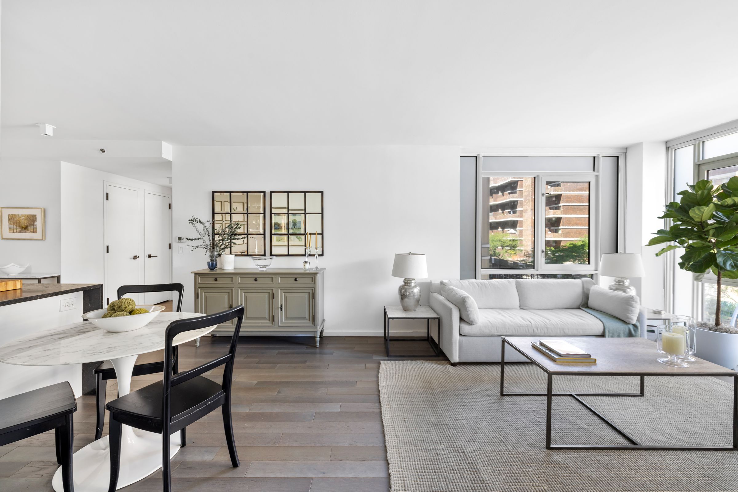 385 1st Avenue, Unit 4B Manhattan, NY 10010 - Photo 2 of 18 a living room with furniture and a window