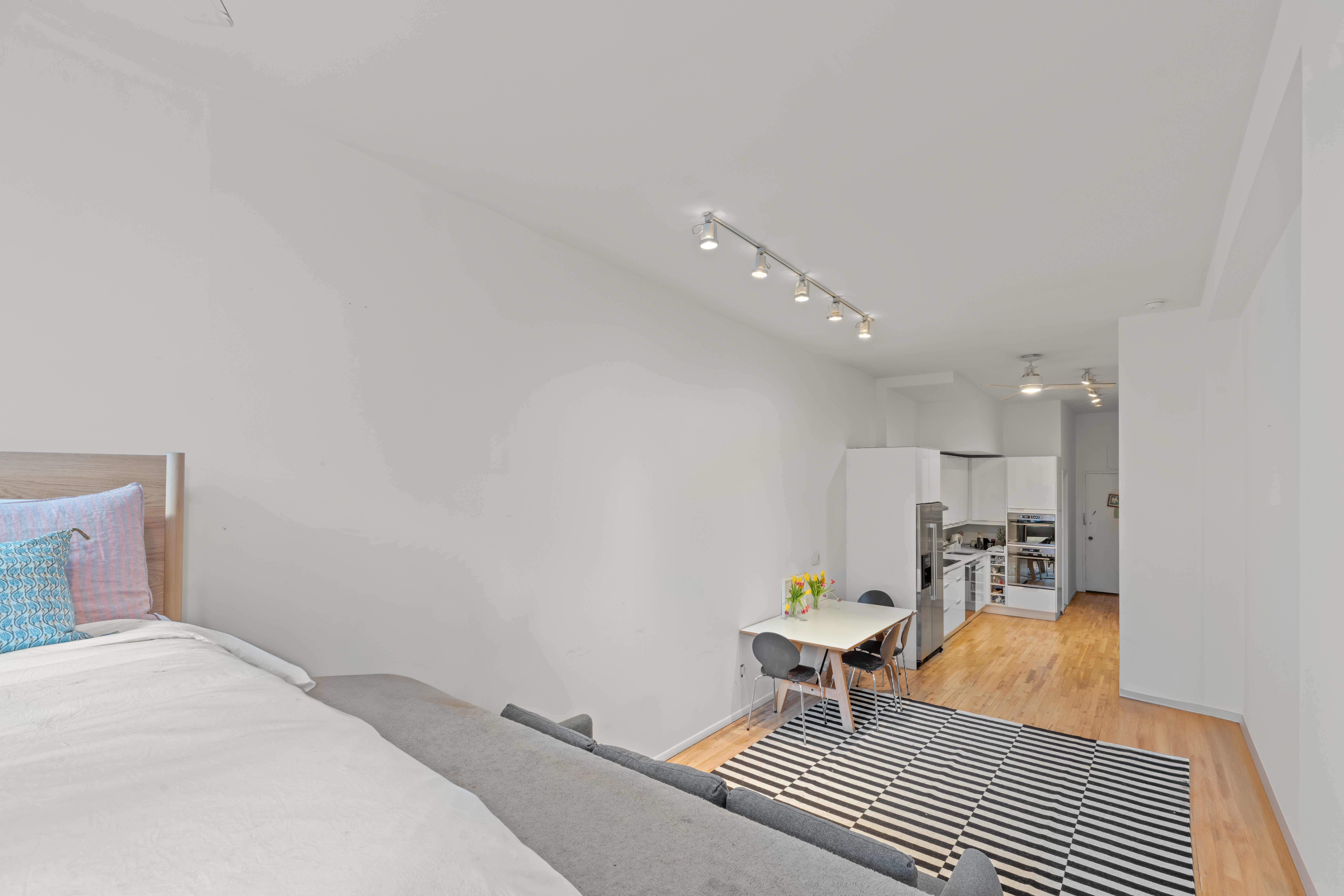 23 Waverly Place, Unit 6M Manhattan, NY 10003 - Photo 7 of 22 a bedroom with a bed and a lamp on desk