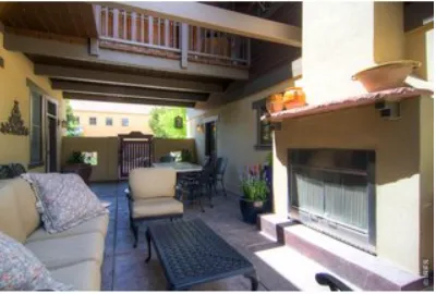 a view of a porch with furniture and a yard