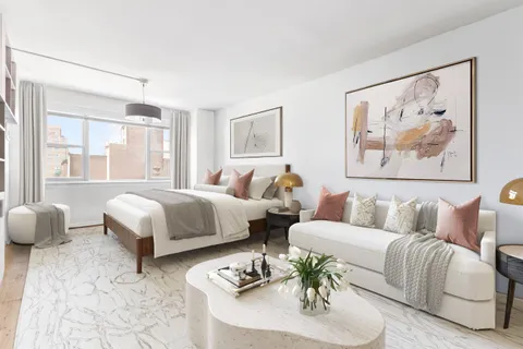 a bedroom with a bed and a couch