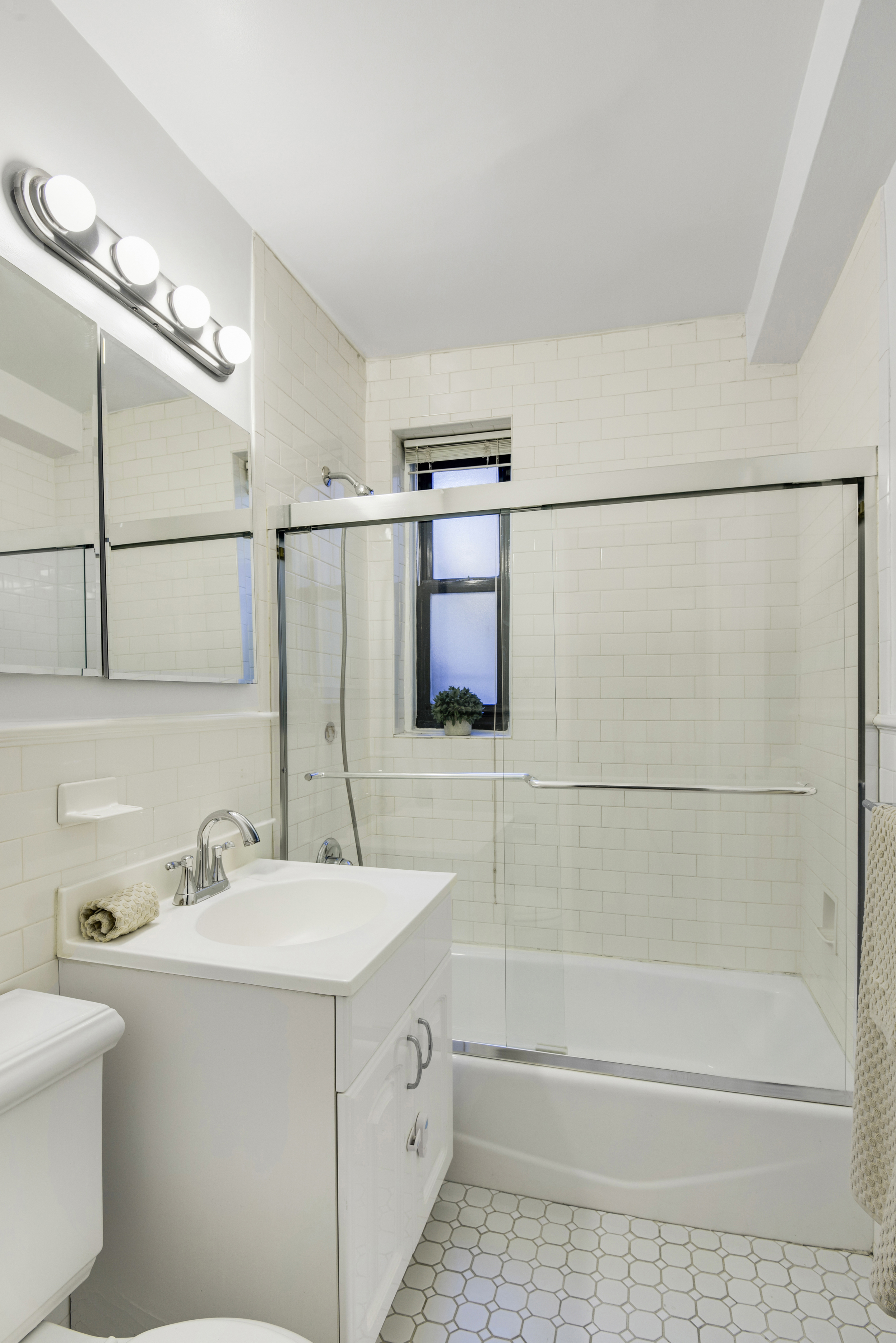330 East 70th Street, Unit 4F Manhattan, NY 10021 - Photo 12 of 14 a bathroom with a sink a toilet and shower