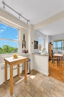 a kitchen with a sink and chairs