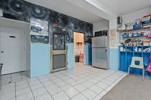 a kitchen with refrigerator and window