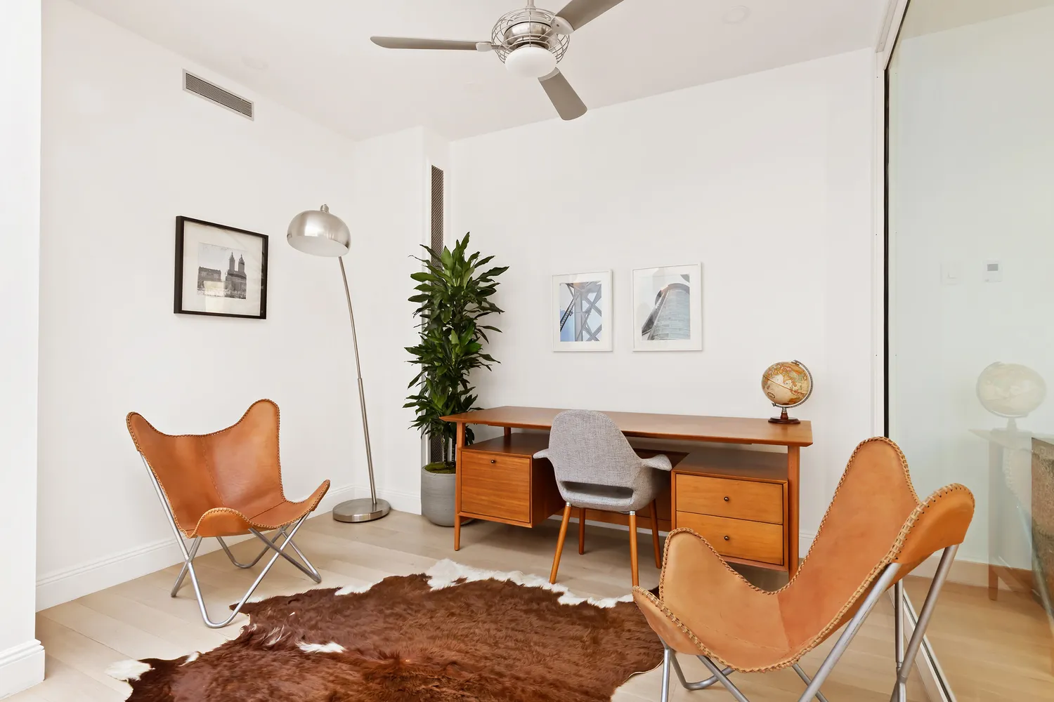 a workspace room with furniture and wooden floor