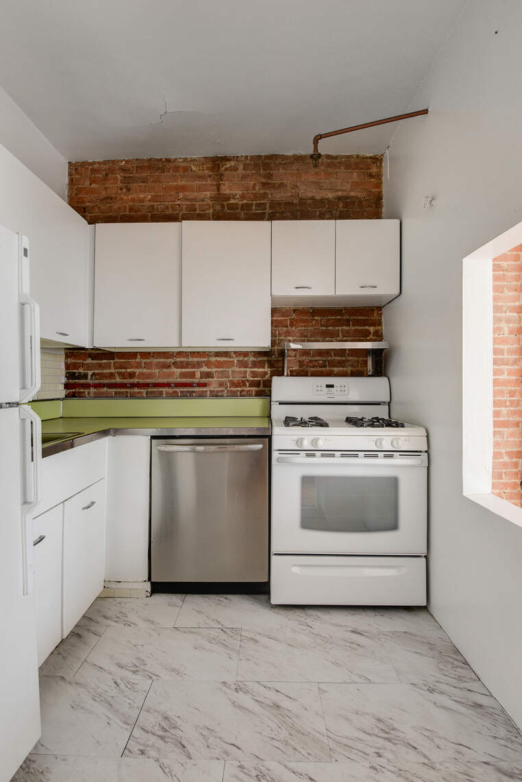 217 West 15th Street Manhattan, NY 10011 - Photo 19 of 21 a white stove top oven sitting inside of a kitchen