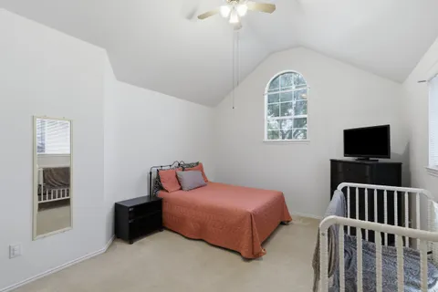 a bedroom with furniture and a flat screen tv