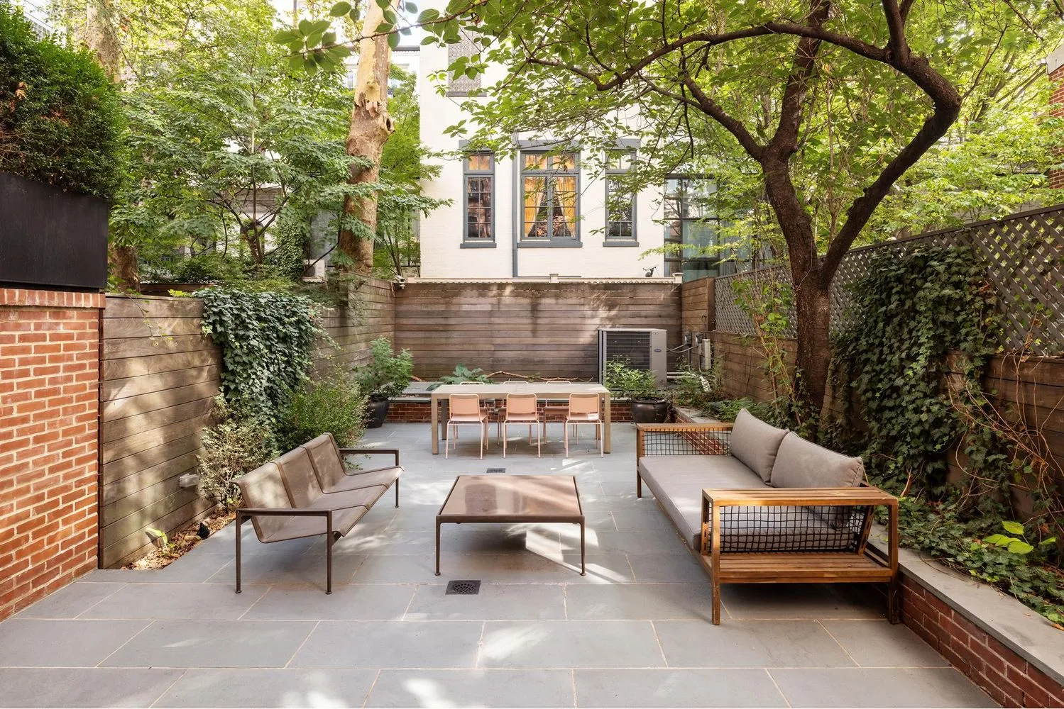 a roof deck with couches and potted plants