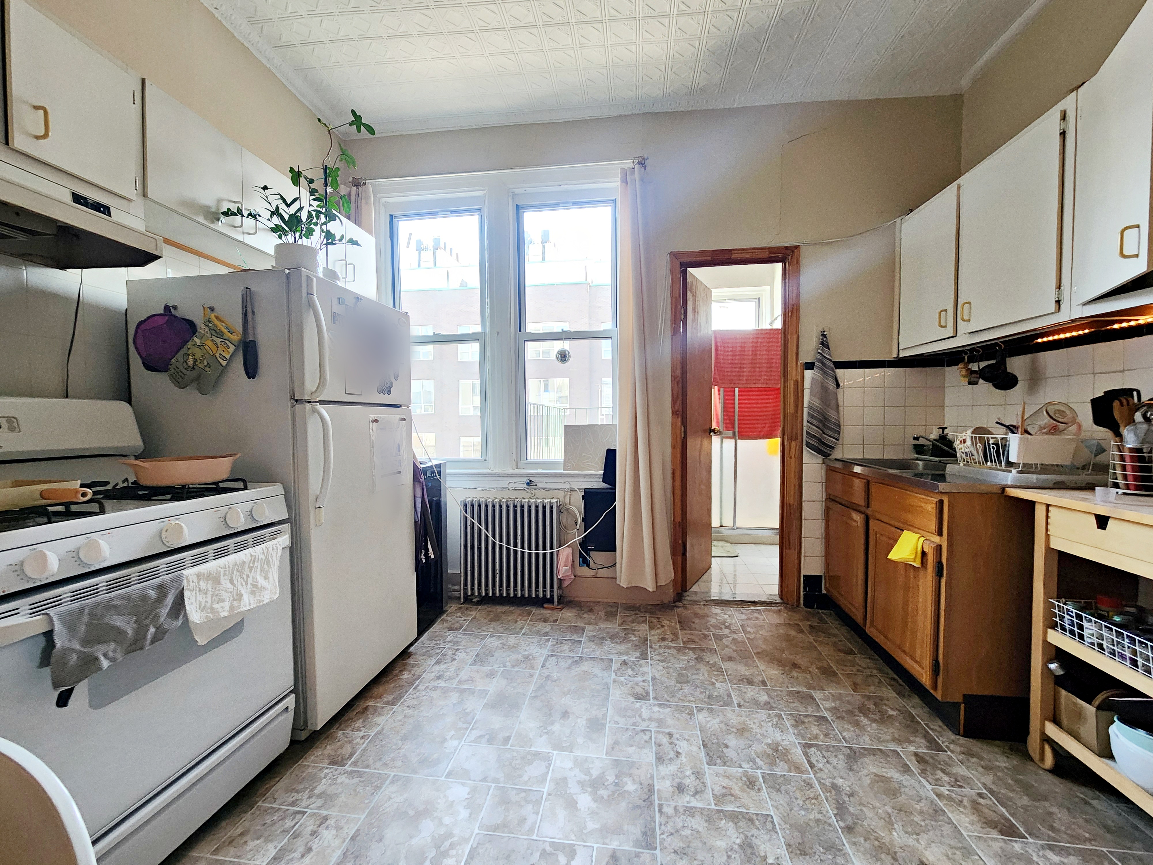148 Withers Street, Unit 3L Brooklyn, NY 11211 - Photo 3 of 9 a kitchen with refrigerator a stove a sink and cabinets