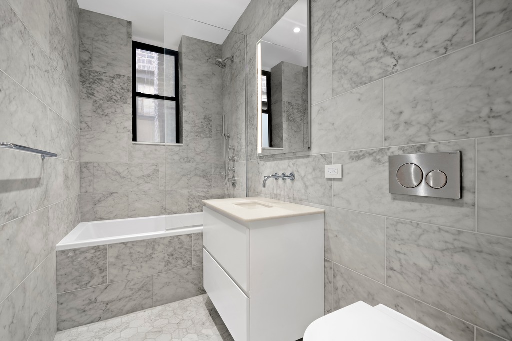 214 Clinton Street, Unit 2E Brooklyn, NY 11201 - Photo 9 of 11 a bathroom with a sink a toilet and shower