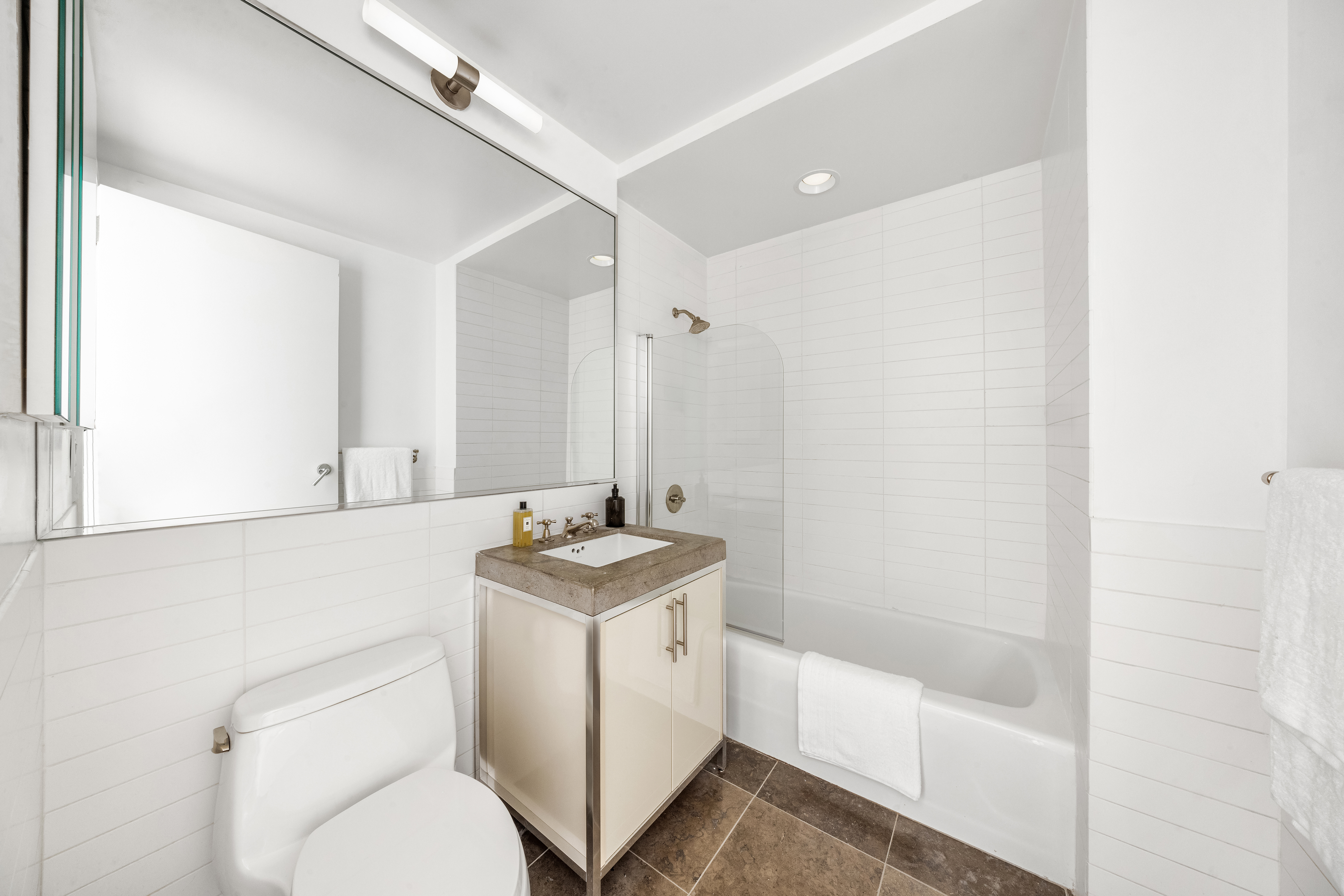 408 East 79th Street, Unit 14B Manhattan, NY 10075 - Photo 14 of 18 a bathroom with a sink a toilet and shower
