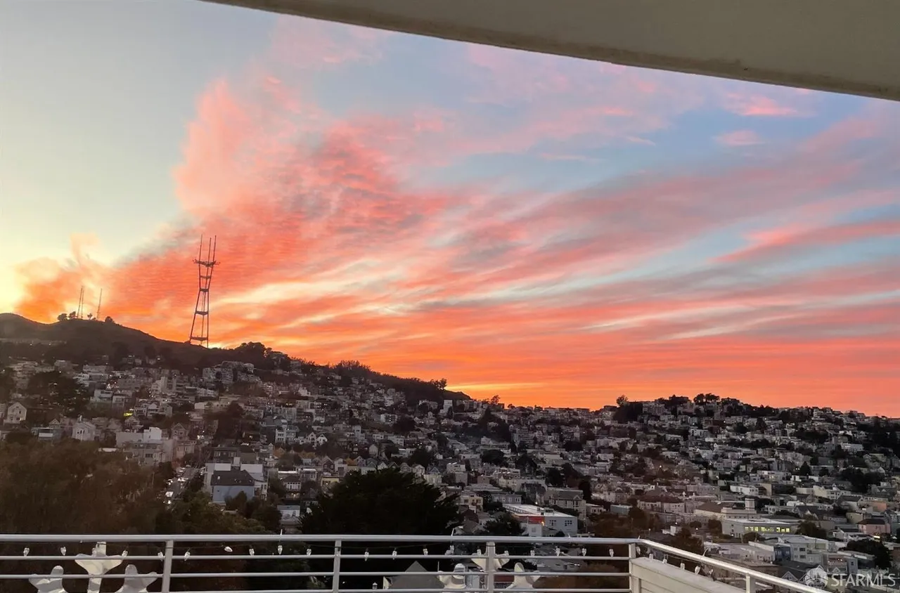 a view of a balcony with two chairs and a table