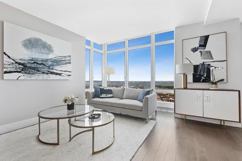 a living room with furniture and kitchen view