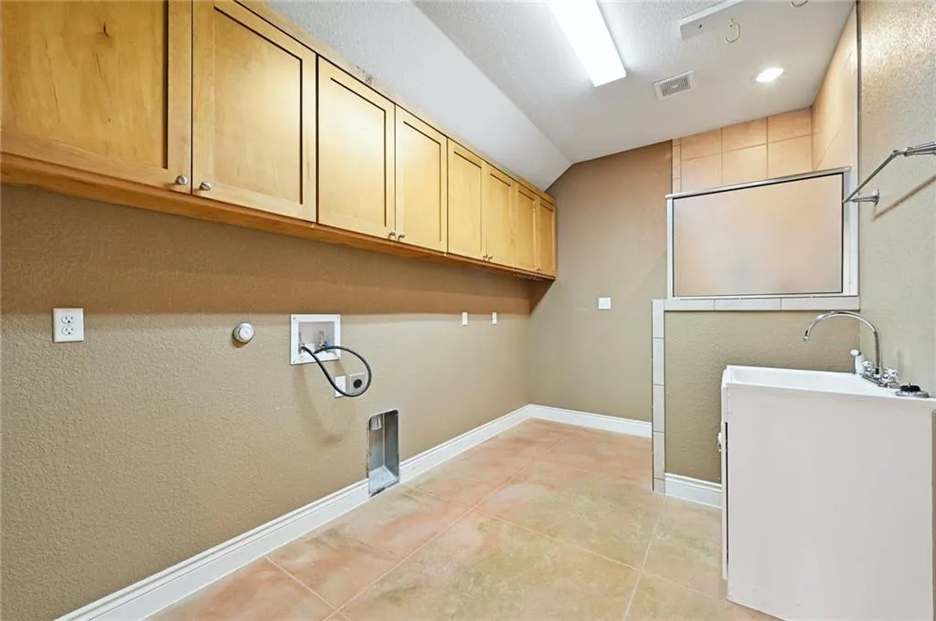 a view of a storage & utility room with a sink