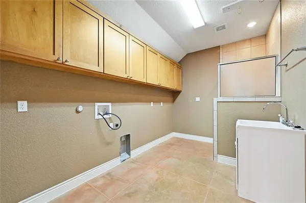 a view of a storage & utility room with a sink
