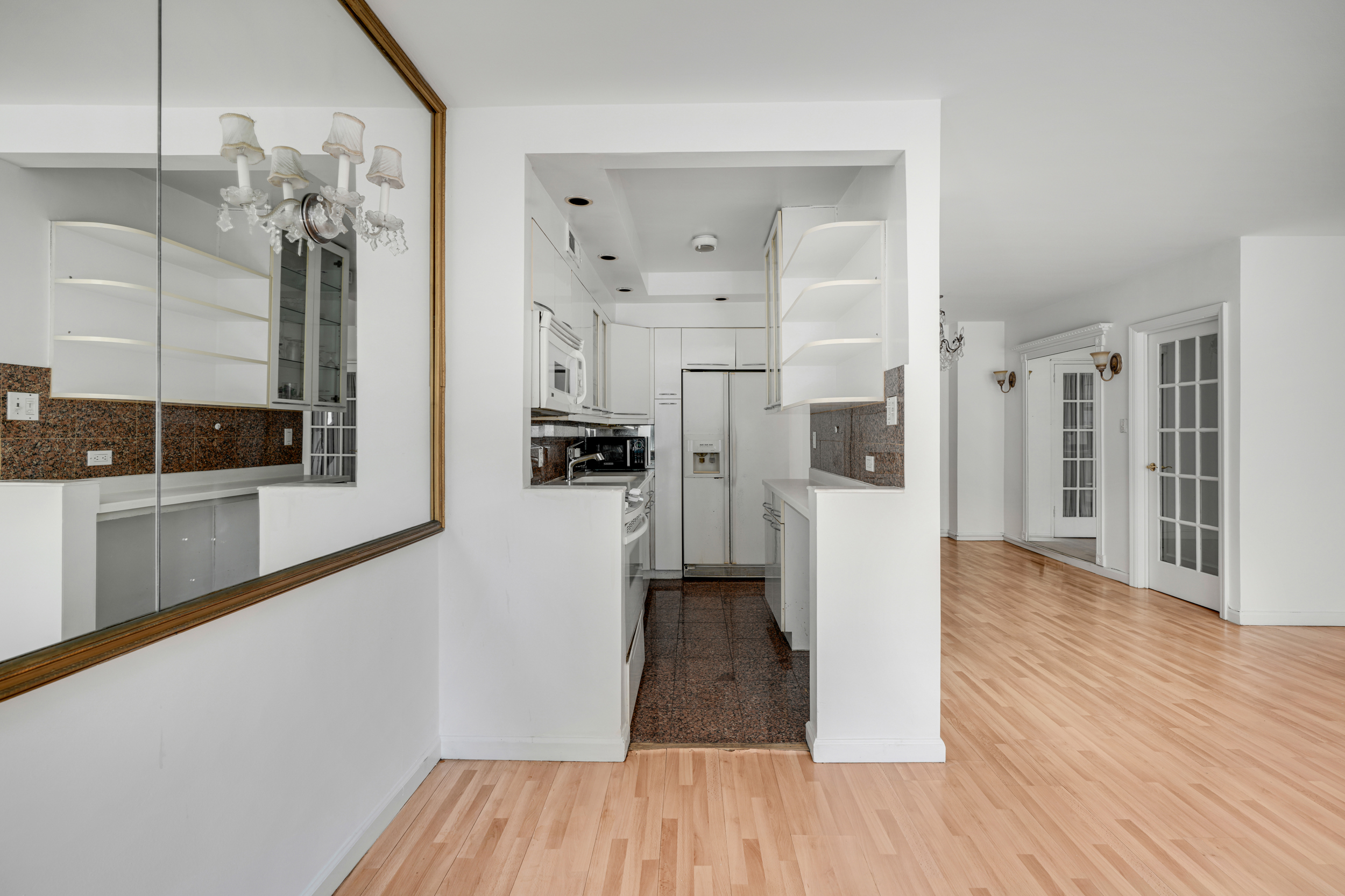357 East 57th Street, Unit 5D Manhattan, NY 10022 - Photo 7 of 23 a view of a bathroom with wooden floor and a glass door