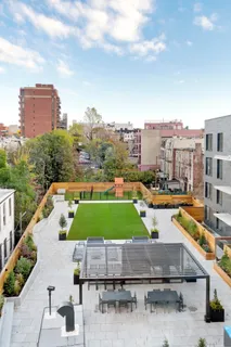 a view of a patio with couches and a table and chairs with garden view
