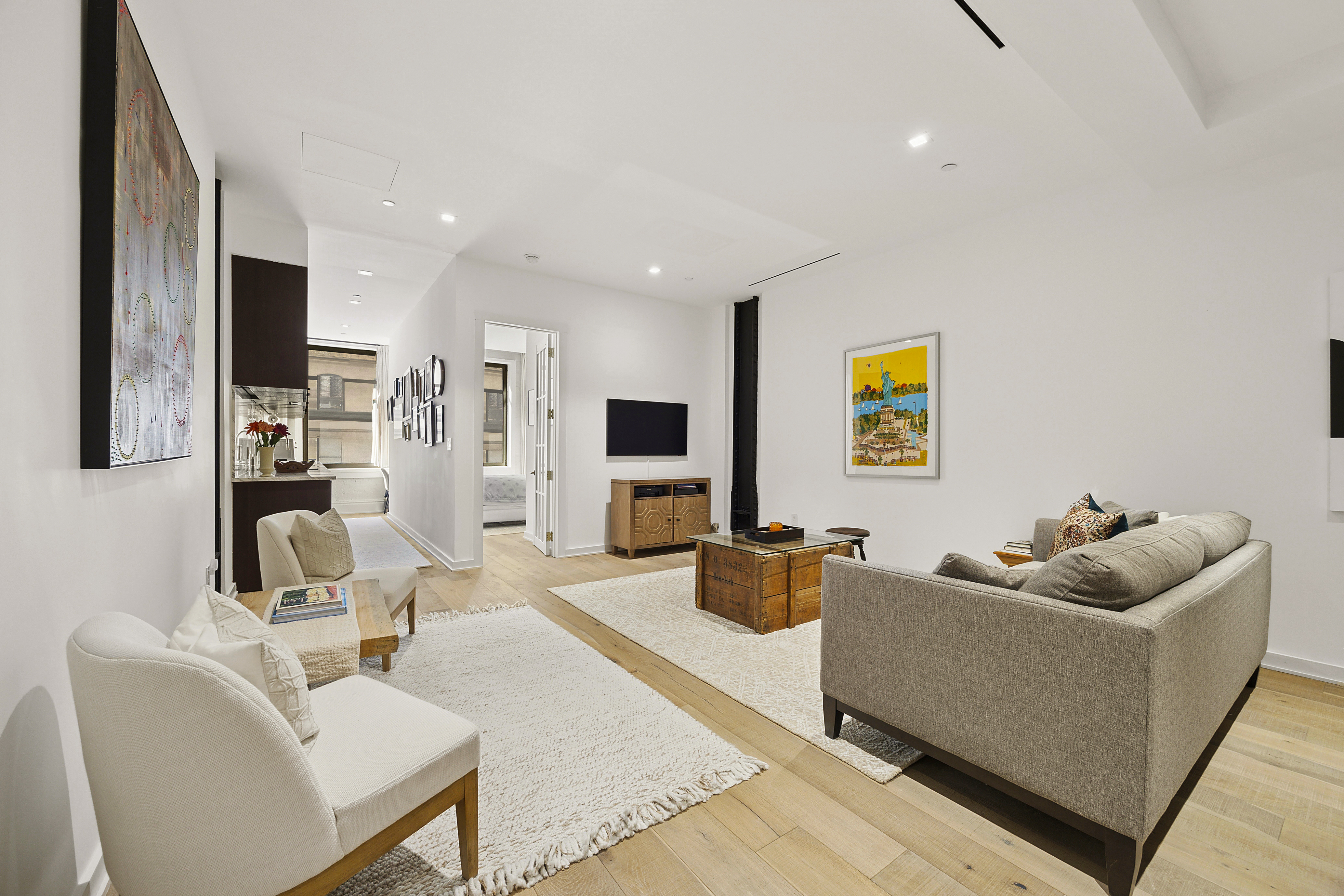 181 Hudson Street, Unit 2B Manhattan, NY 10013 - Photo 3 of 10 a living room with furniture and a flat screen tv