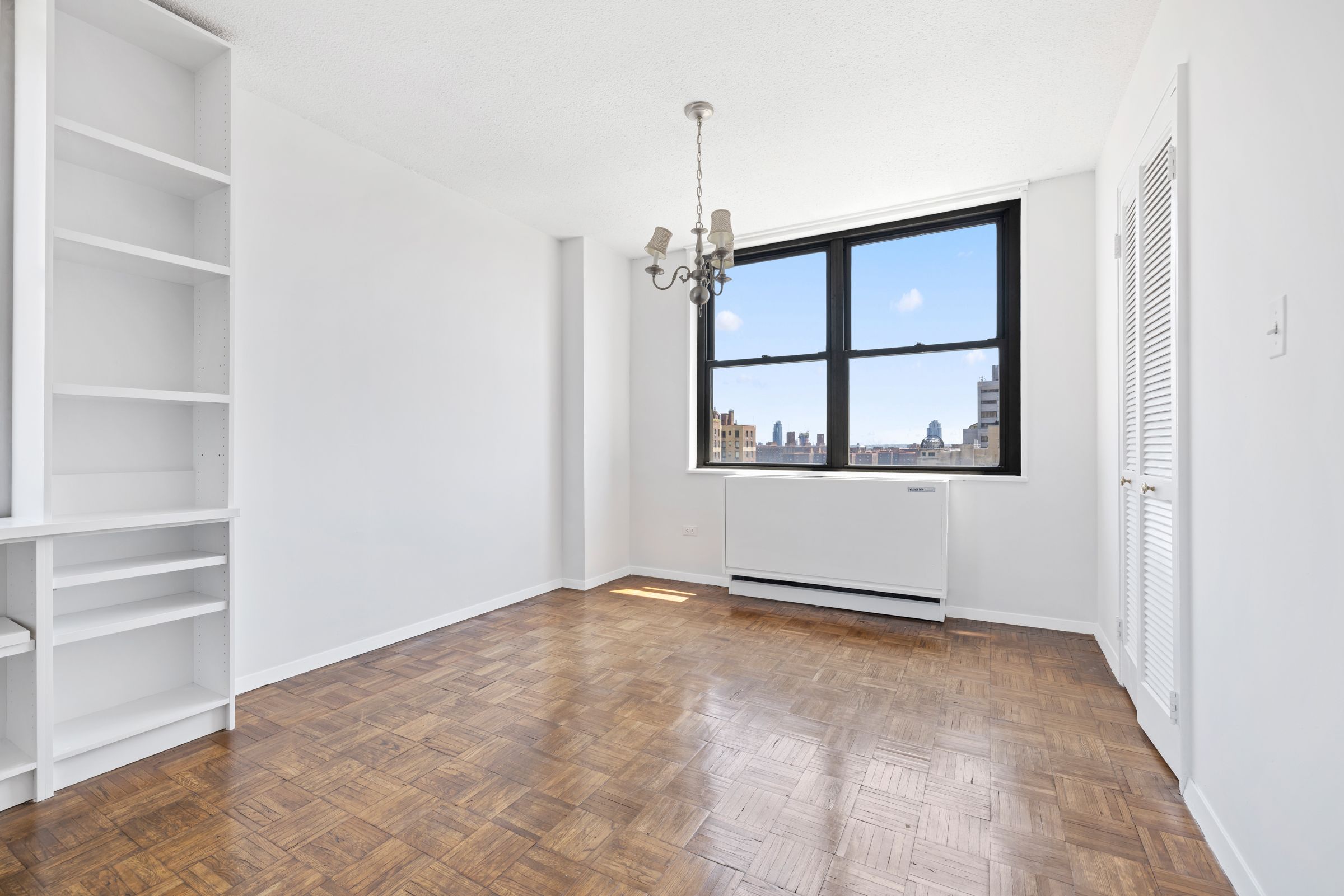 201 East 17th Street, Unit 15H Manhattan, NY 10003 - Photo 6 of 24 a view of an empty room with a window