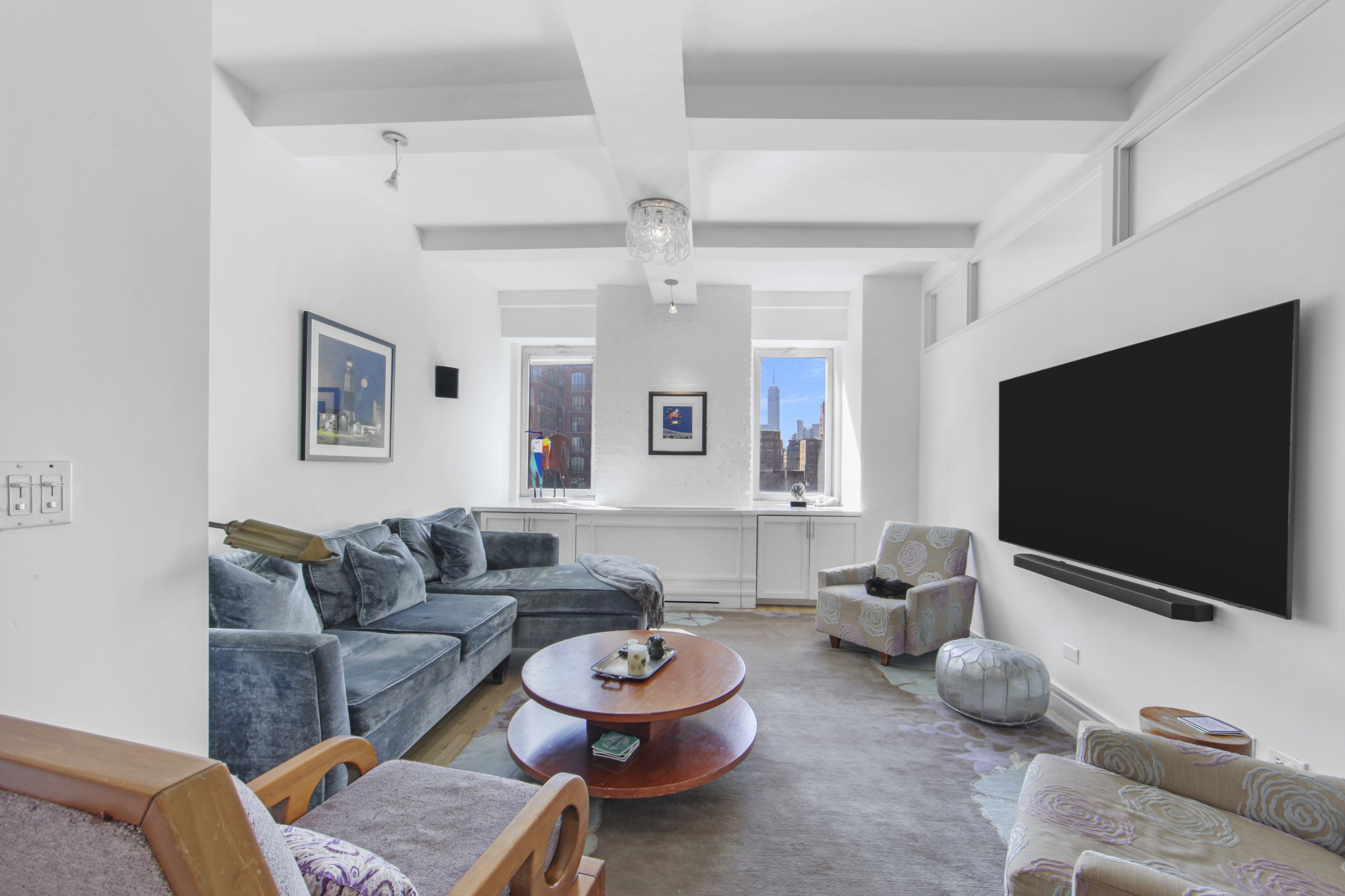 18 East 12th Street, Unit 7BC Manhattan, NY 10003 - Photo 3 of 26 a living room with furniture and a flat screen tv