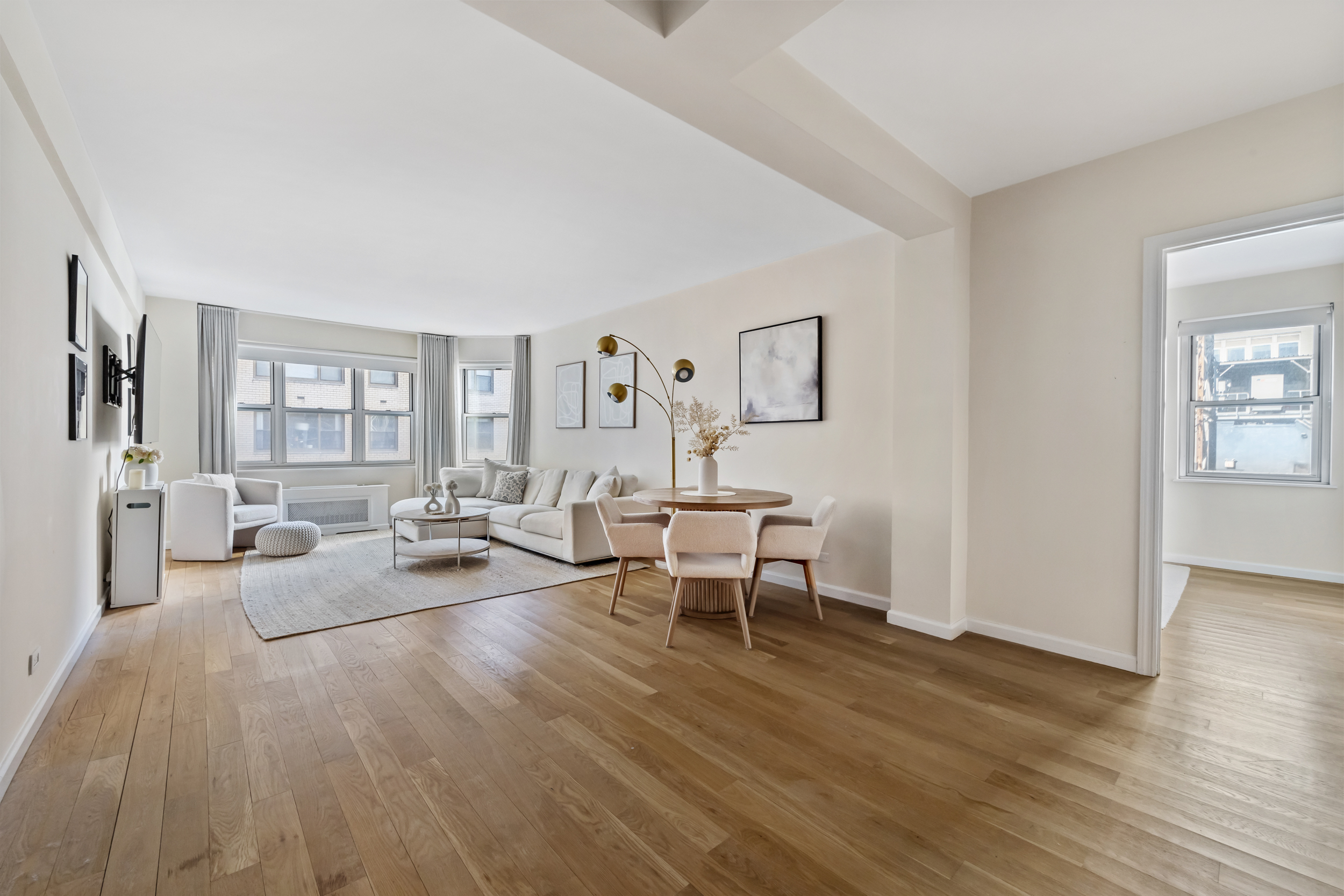 80 Park Avenue, Unit 11D Manhattan, NY 10016 - Photo 3 of 7 a living room with furniture and wooden floor