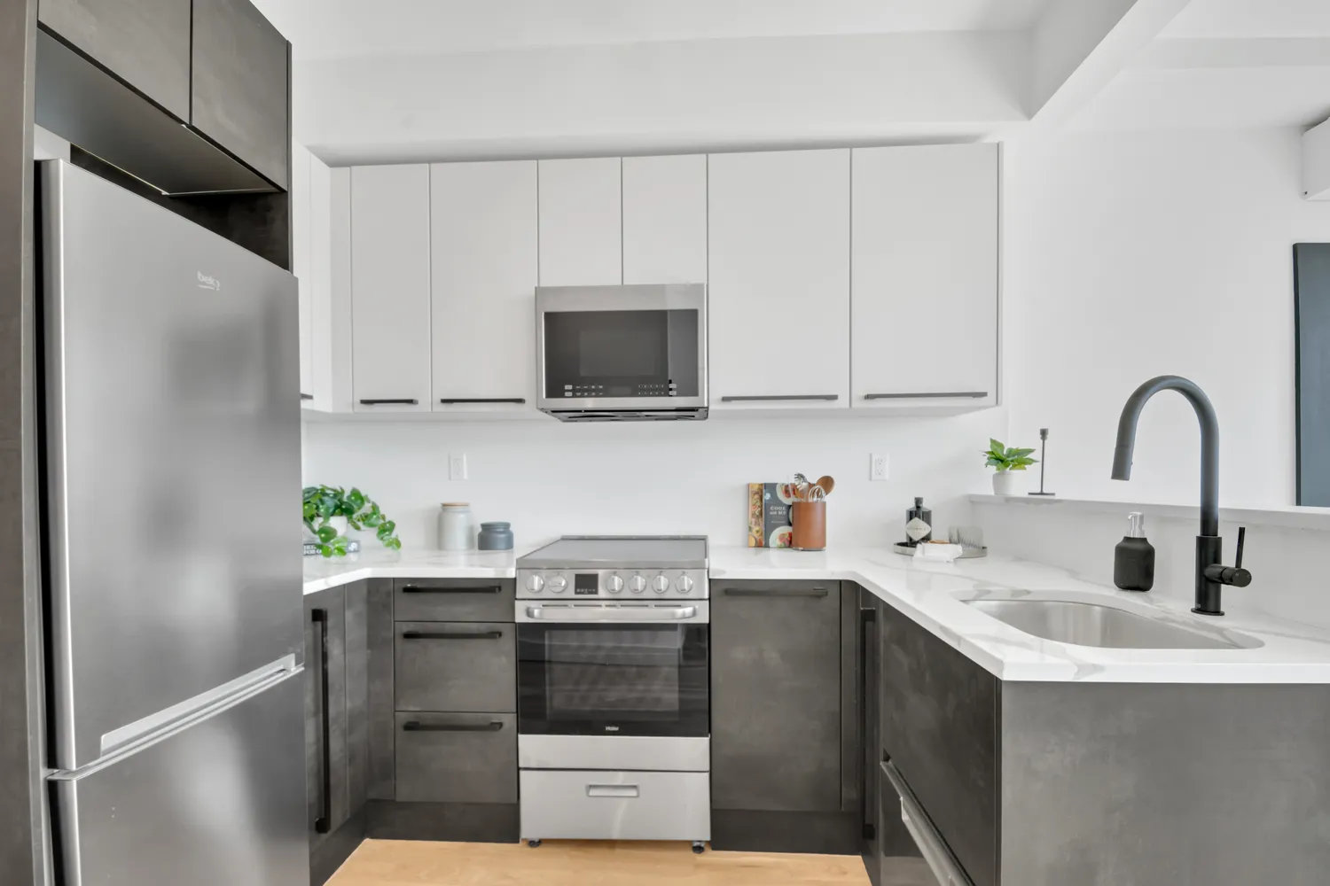 a kitchen with stainless steel appliances a sink a stove and a refrigerator
