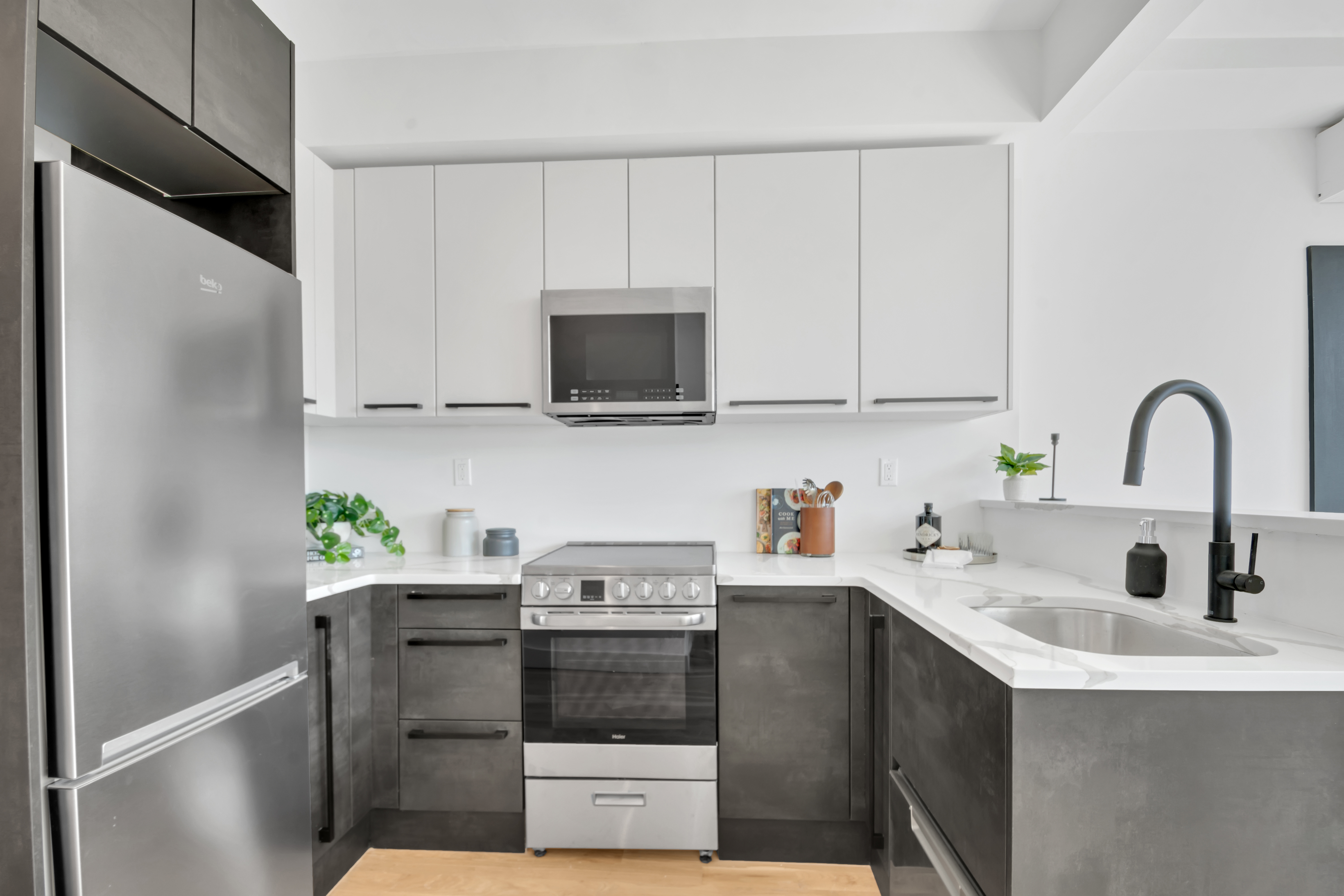 145 West 129th Street, Unit 4 Manhattan, NY 10027 - Photo 4 of 11 a kitchen with stainless steel appliances a sink a stove and a refrigerator