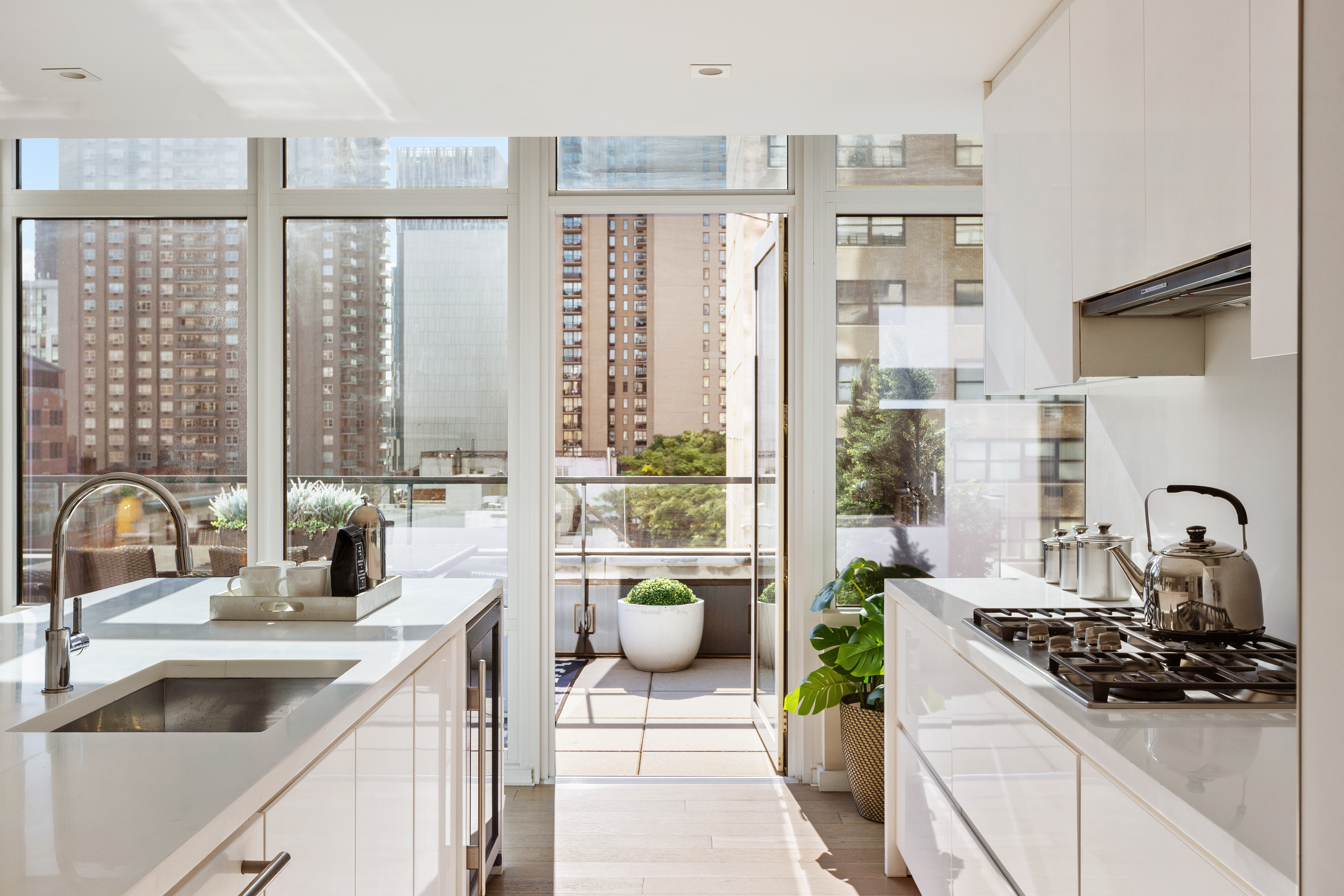 1355 1st Avenue, Unit 8 Manhattan, NY 10021 - Photo 7 of 25 a kitchen with a sink and a stove top oven