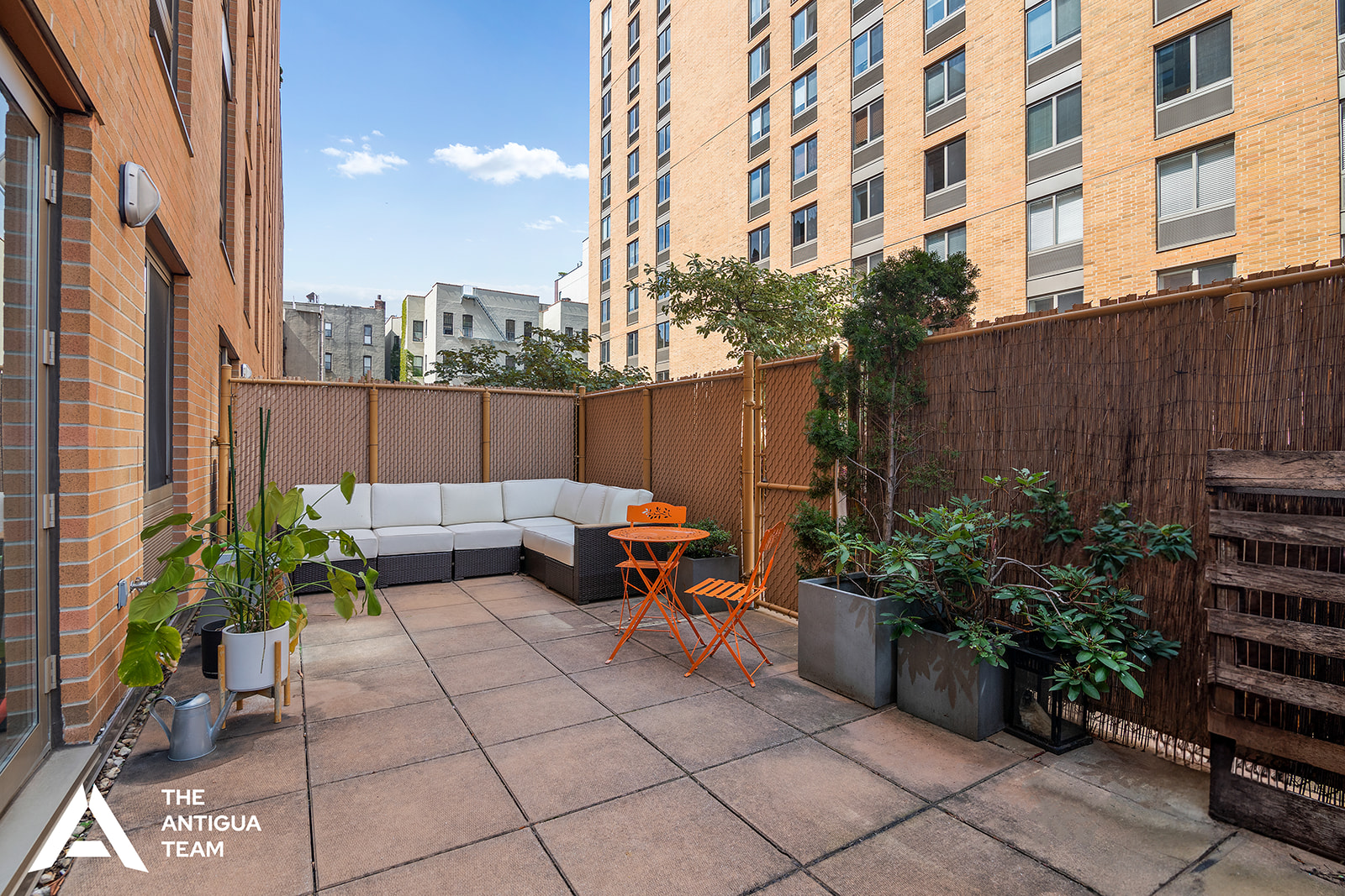 300 West 135th Street, Unit 2M Manhattan, NY 10030 - Photo 2 of 8 a backyard of a house with barbeque oven and potted plants