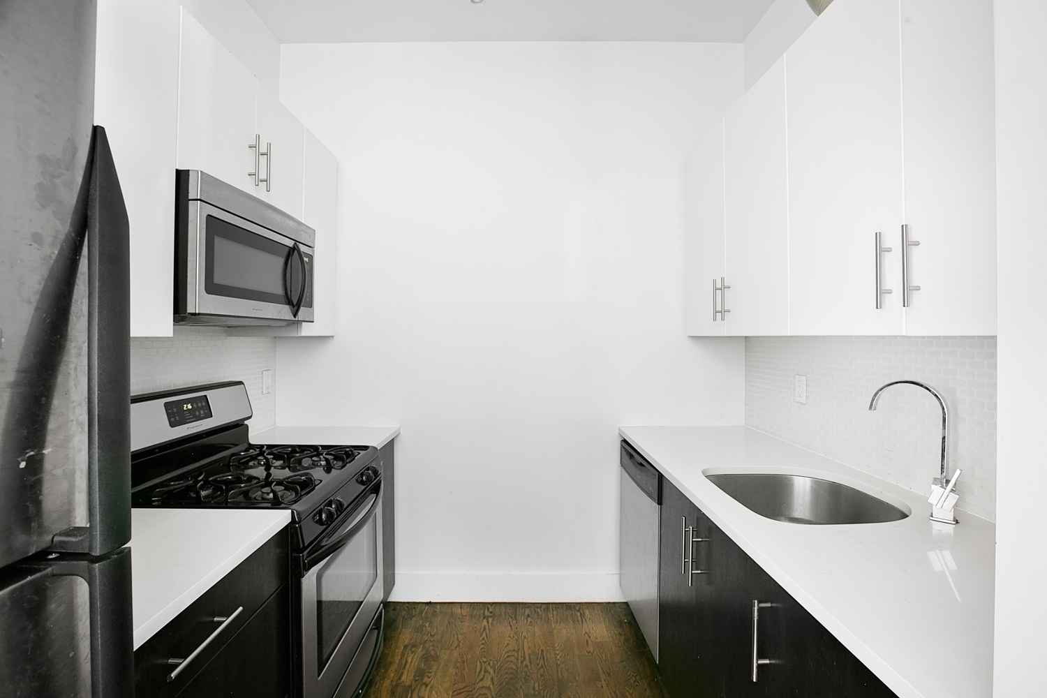 59 Hawthorne Street, Unit 3D Brooklyn, NY 11225 - Photo 4 of 6 a kitchen with stainless steel appliances granite countertop a sink stove and microwave