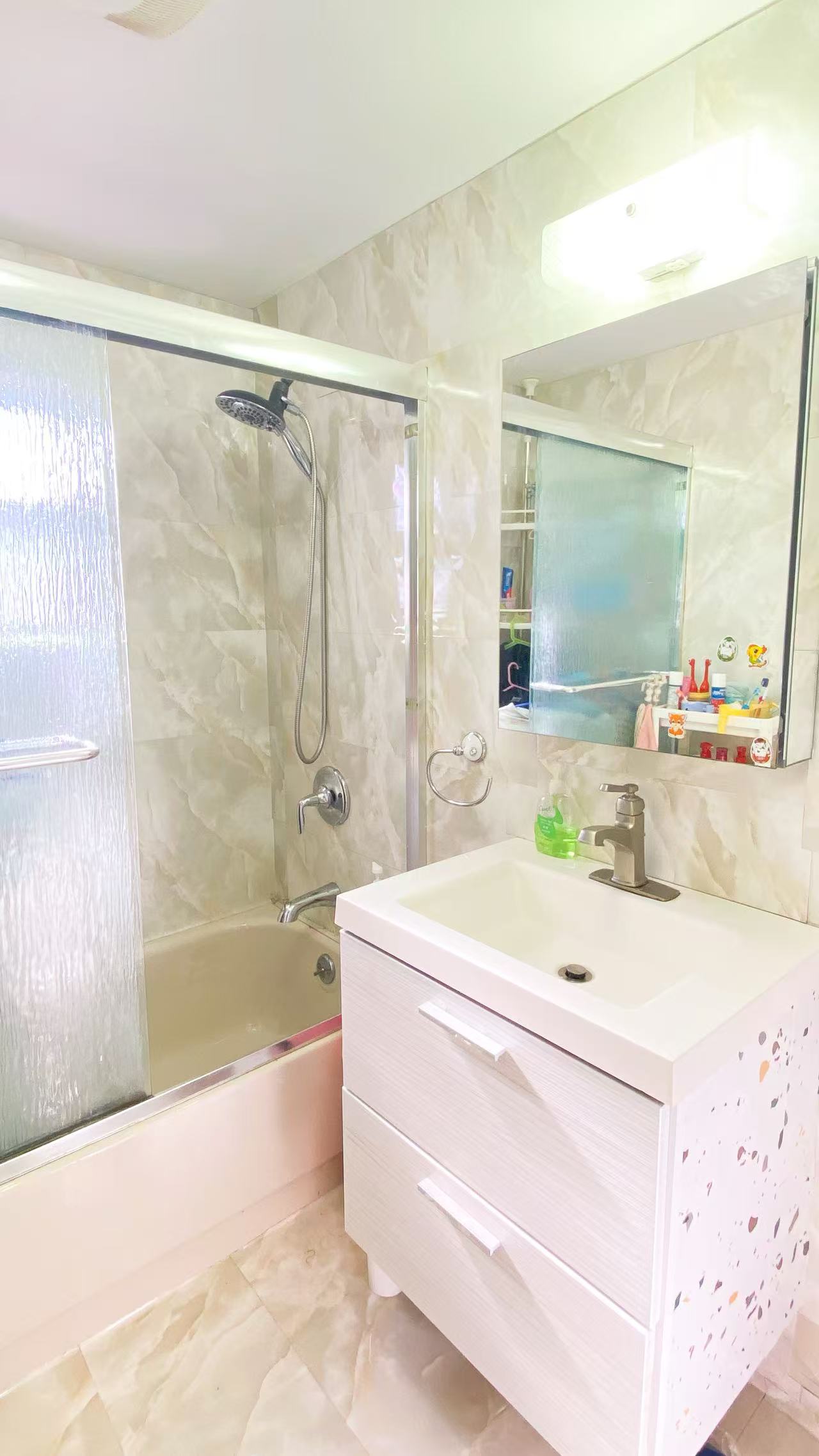 10 Church Street Queens, NY 11414 - Photo 8 of 14 a bathroom with a sink a bathtub and a shower