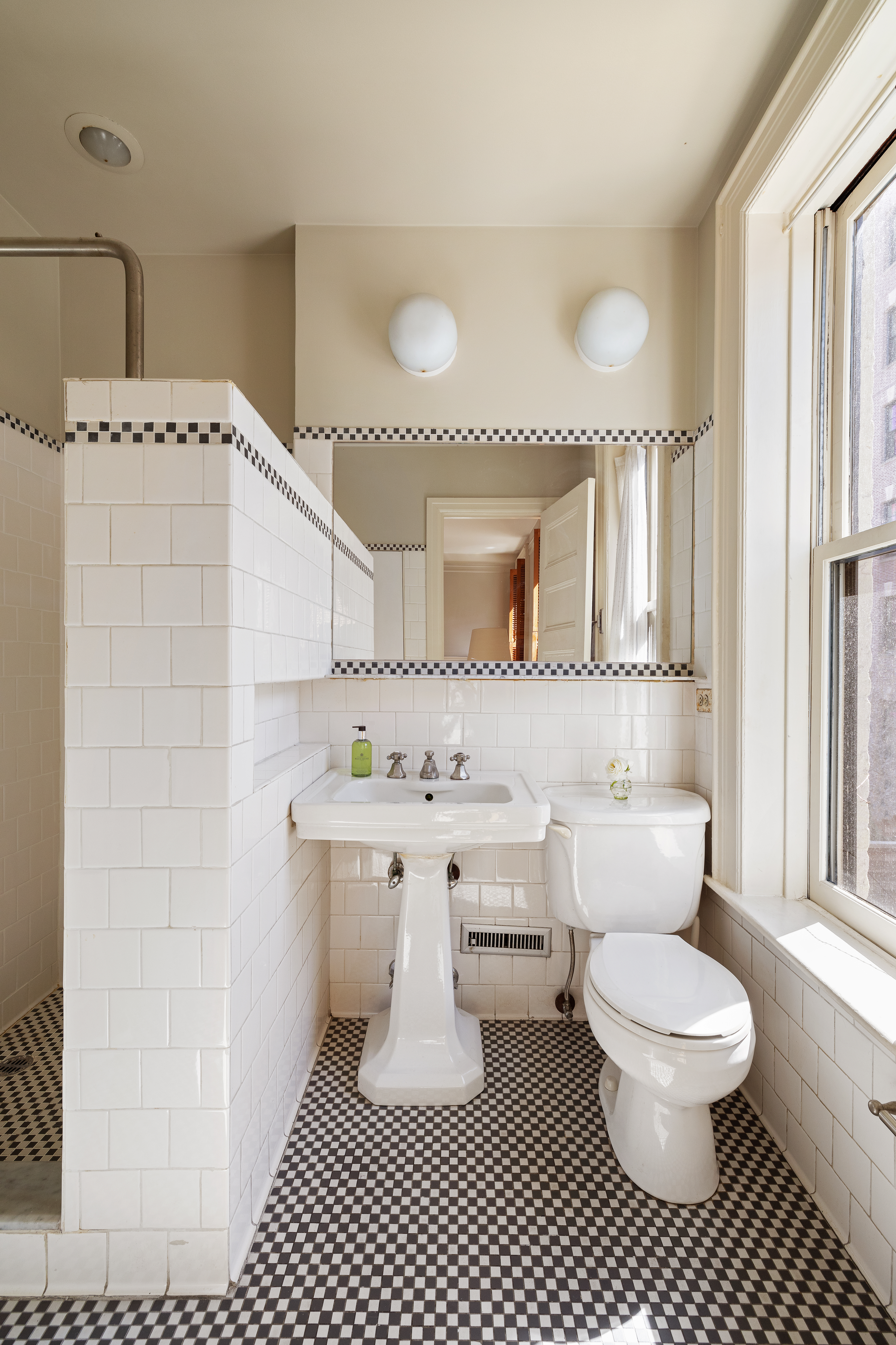 26 Pierrepont Street, Unit 2 Brooklyn, NY 11201 - Photo 13 of 21 a bathroom with a sink toilet a mirror and shower