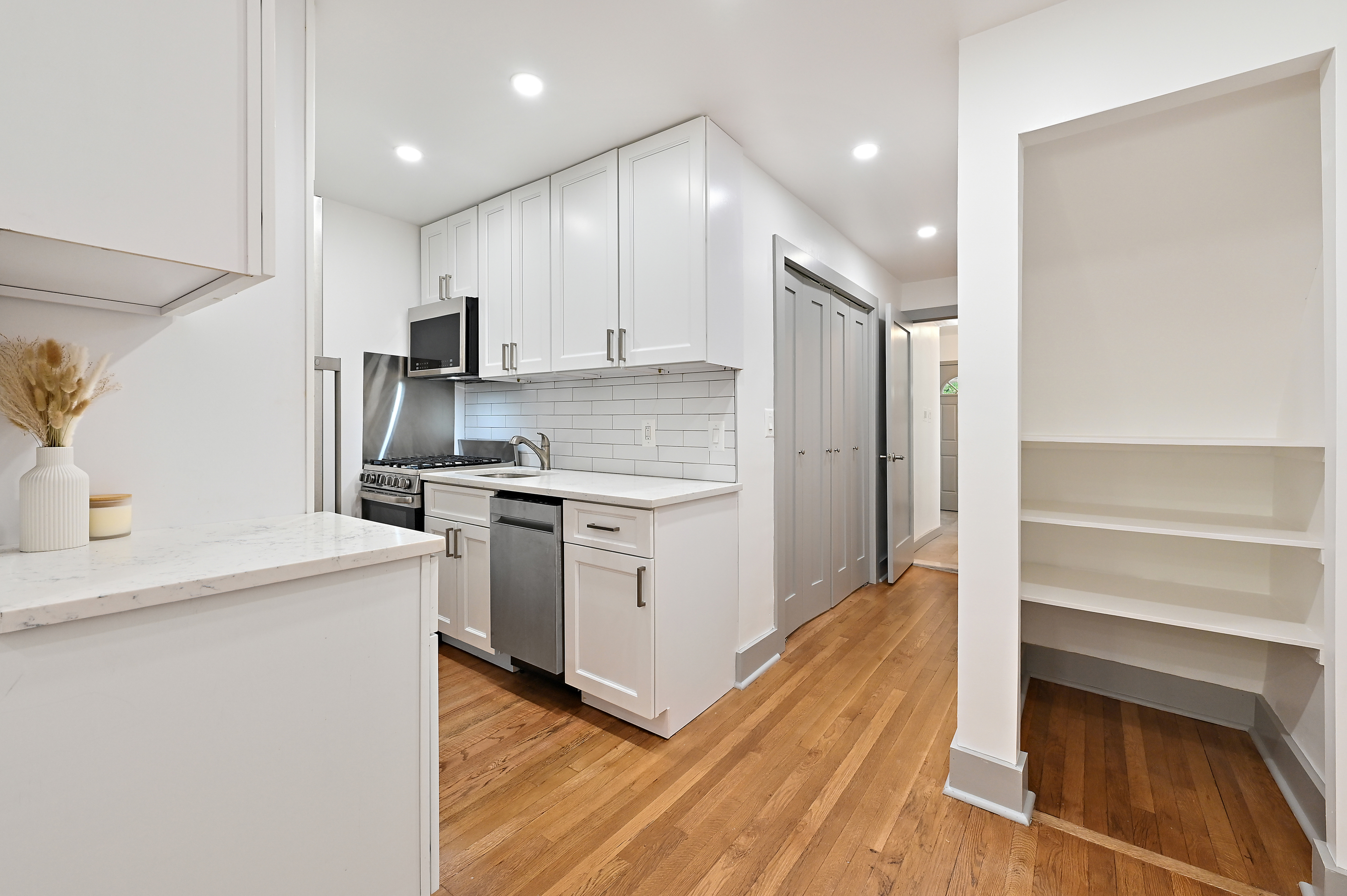 5823 Fieldston Road, Unit 1A Bronx, NY 10471 - Photo 2 of 26 a kitchen with a refrigerator and a stove top oven