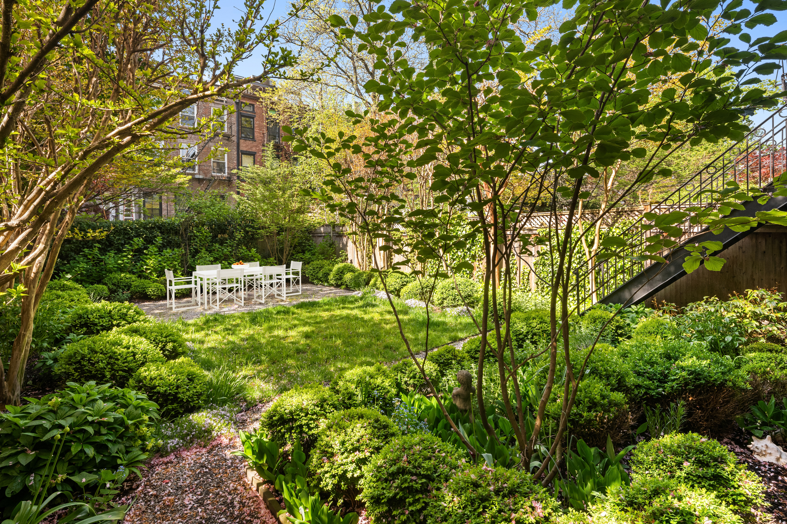 204 Warren Street Brooklyn, NY 11201 - Photo 28 of 29 a backyard of a house with large trees and plants
