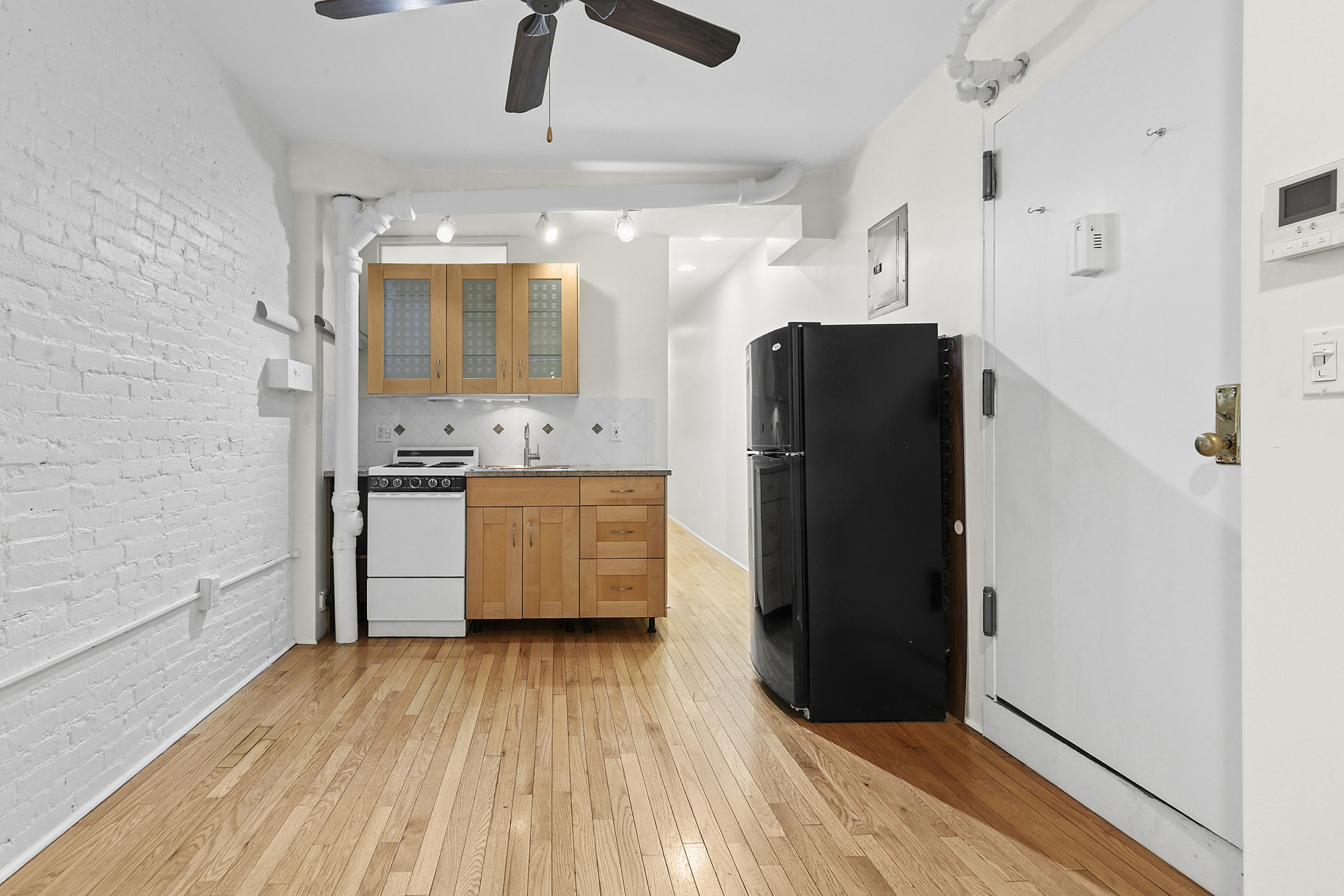 140 West 10th Street, Unit BTE Manhattan, NY 10014 - Photo 2 of 12 a kitchen with stainless steel appliances a refrigerator and a stove top oven