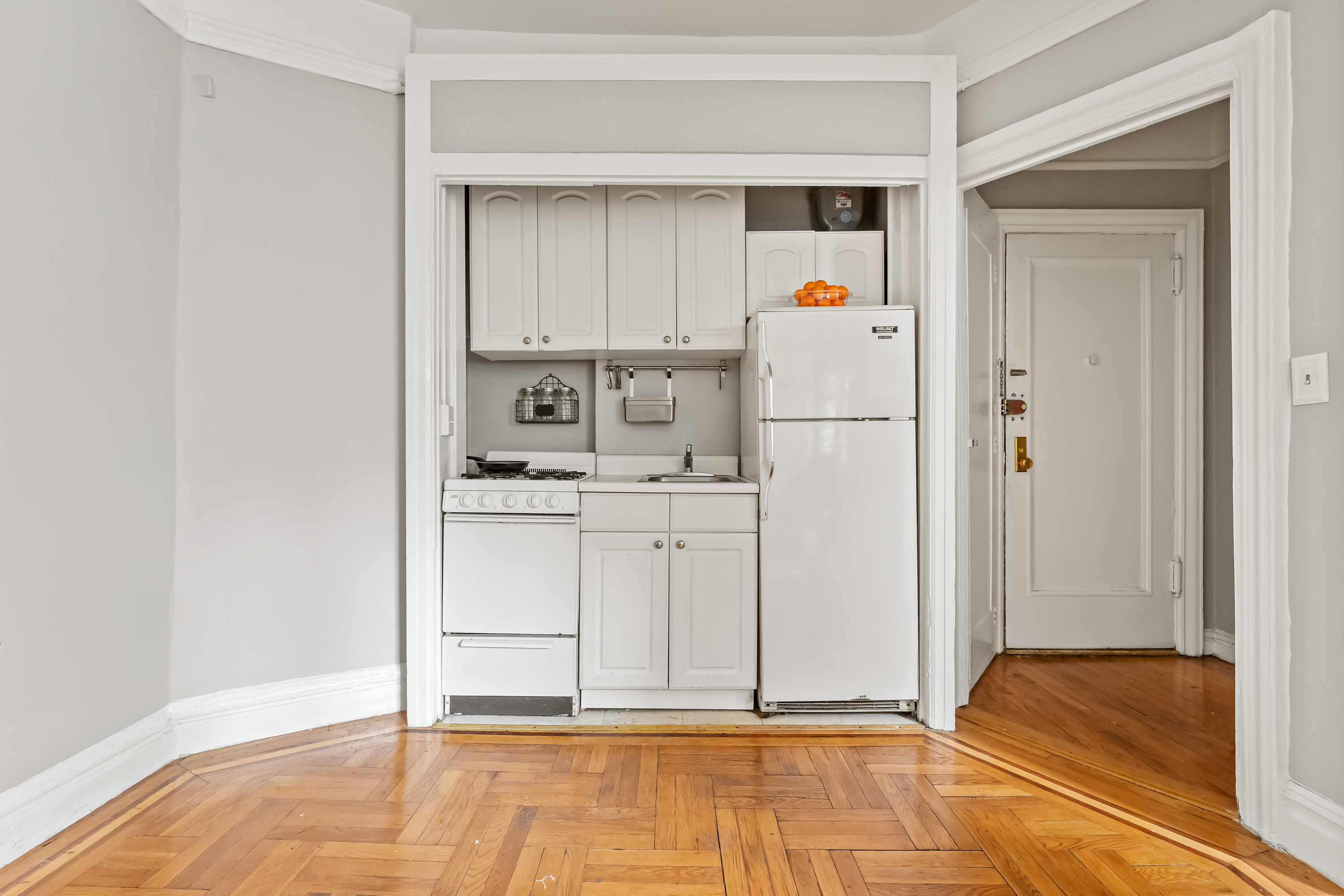 345 East 77th Street, Unit 4I Manhattan, NY 10075 - Photo 3 of 4 a room with white cabinets and white appliances