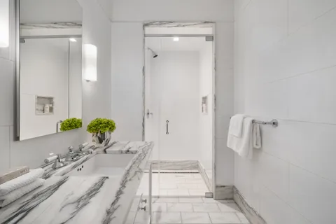a spacious bathroom with a granite countertop sink and a mirror